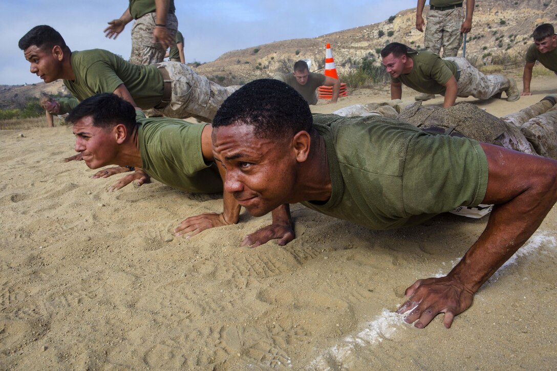 Marines participate in a push-up event during the 2016 World Famous Mud Run by Lake O'Neill at Camp Pendleton, Calif., June 3, 2016. Marine Corps photo by Cpl. Travis Jordan