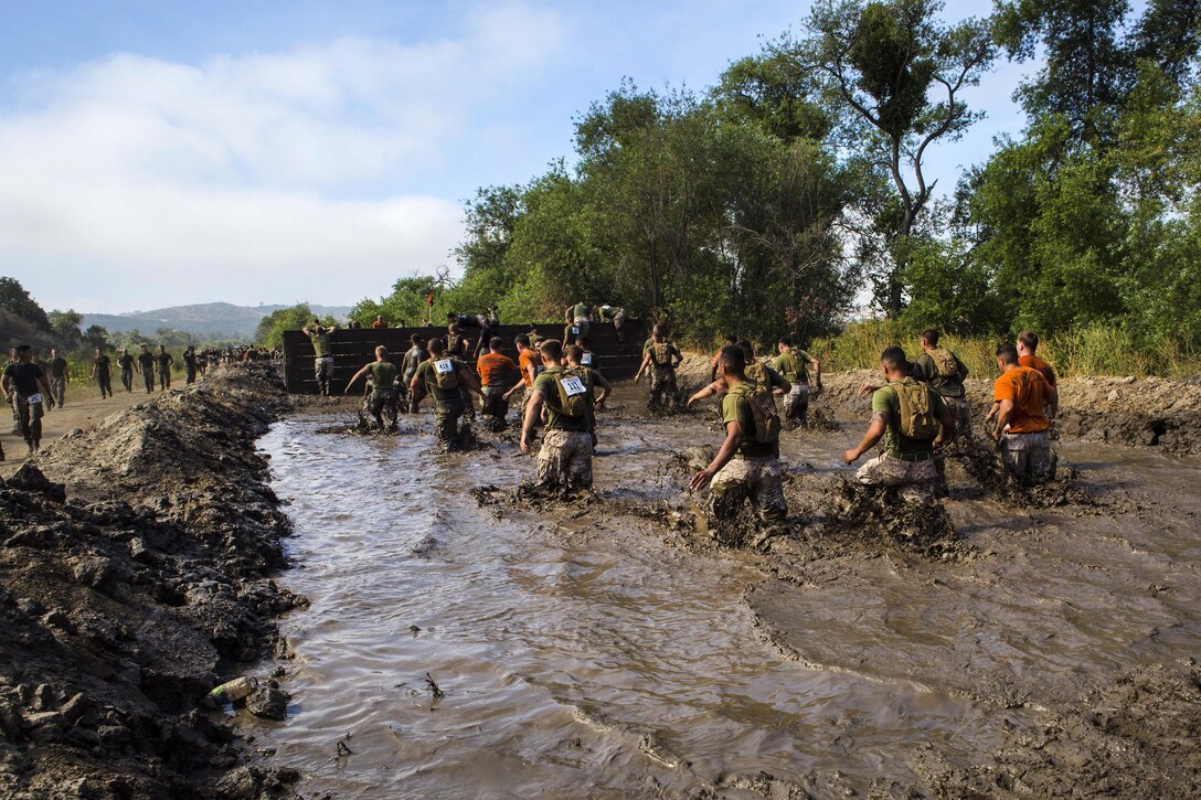Marines and sailors participate in the mud pit run during the 2016 World Famous Mud Run by Lake O'Neill at Camp Pendleton, Calif., June 3, 2016. Marine Corps photo by Cpl. Travis Jordan