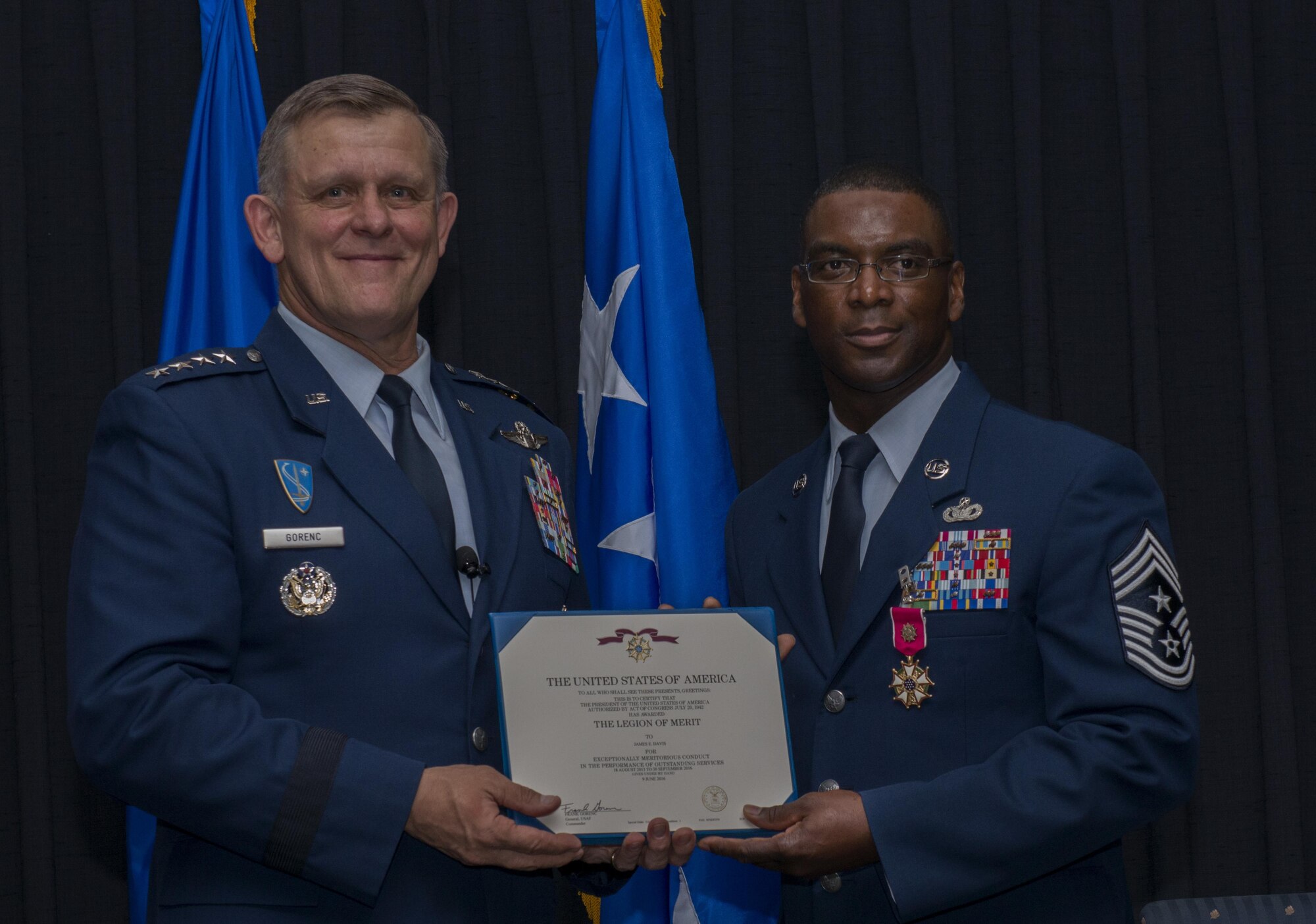 Gen. Frank Gorenc, U.S. Air Forces in Europe and U.S. Air Forces Africa commander, presents Chief Master Sgt. James E. Davis, USAFE-AFAFRICA command chief, a certificate for the Legion of Merit during Davis’ retirement ceremony June 13, 2016, at Ramstein Air Base, Germany. Davis entered in the Air Force in 1986, served for 30 years and has been stationed at Ramstein since August 2013. (U.S Air Force photo/Airman 1st Class Tryphena Mayhugh)