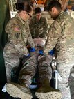 Spc. Rebecca Hutchins of Riverside, Calif., and Spc. Javier Pacheco of El Paso, Texas, tie tourniquets on the legs of Staff Sgt. Steven Trudel of Lancaster, Pa. as Sgt. James Sutton of Valdosta, Ga. stabilizes Trudel’s head in a simulated rehearsal. The combat medics are in Poland for Exercise Anakonda 2016, a Polish-led, multinational exercise that includes over 31,000 troops from 24 participating nations. (U.S. Army photo by 1st Lt. Ernest Wang/Released)
