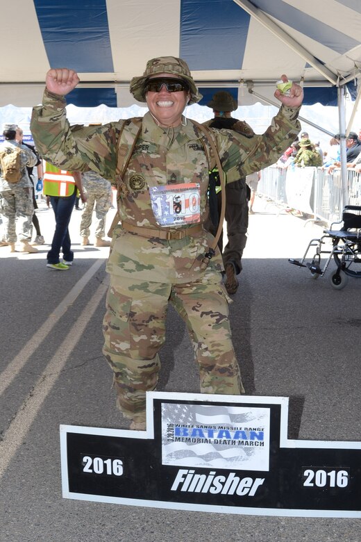 Master Sgt. Yesenia Cooper, NCOIC, ARCOG’s Western Cyber Protection Center, finishes the Bataan Death March held in White Sands Missile Range, NM, March 22, 2016. Cooper completed the 26.2-mile event in six hours, nine minutes, and 54 seconds, and scores second place in her category: military female light individual, 40-49 years of age. (Photo courtesy of MARATHONFOTO.) 