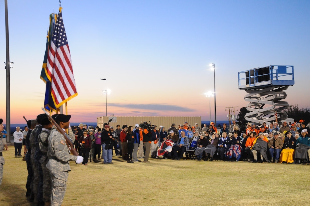Honor Guard presents the flags to the survivors of the Bataan Death March during the annual event at White Sands Missile Range, NM, March 22, 2016.  The presentation of the flag to the surviving members of the Bataan Death March was in honor of their service and sacrifices while defending the Philippine islands during World War II. (Photo courtesy of MARATHONFOTO.) 