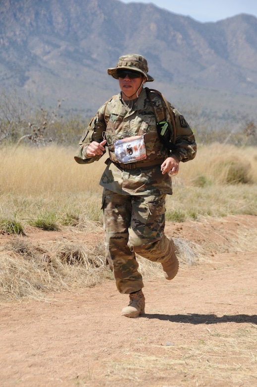 Master Sgt. Yesenia Cooper, NCOIC, ARCOG’s Western Cyber Protection Center, toughs it out in the heat of New Mexico desert during the Bataan Death March held in White Sands Missile Range, March 22, 2016. The Bataan Death March is a 26.2-mile march held annually to commemorate the honor, service and sacrifice of the heroic service members who defended the Philippine Islands during World War II.(Photo courtesy of MARATHONFOTO.)