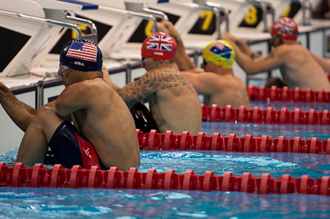 Retired U.S. Army Staff Sgt. Michael Kacer, left, prepares for the 50-meter backstroke race during the swimming portion of the Invictus Games 2014 in London Sept. 14, 2014. The Invictus Games brings together wounded veterans from 14 nations for events including track and field, archery, wheelchair basketball, road cycling, indoor rowing, wheelchair rugby, swimming, sitting volleyball and a driving challenge. DoD photo by Senior Airman Justyn M. Freeman
