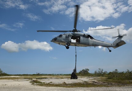 Naval Air Station Key West's Search and Rescue team delivers a sling load of communications equipment to NAS Key West's Saddlebunch Key after picking it up from Fleming Key. The equipment move was part of a communications training operation for the Florida Air National Guard's 290th Joint Communications Support Squadron out of MacDill Air Force Base.  