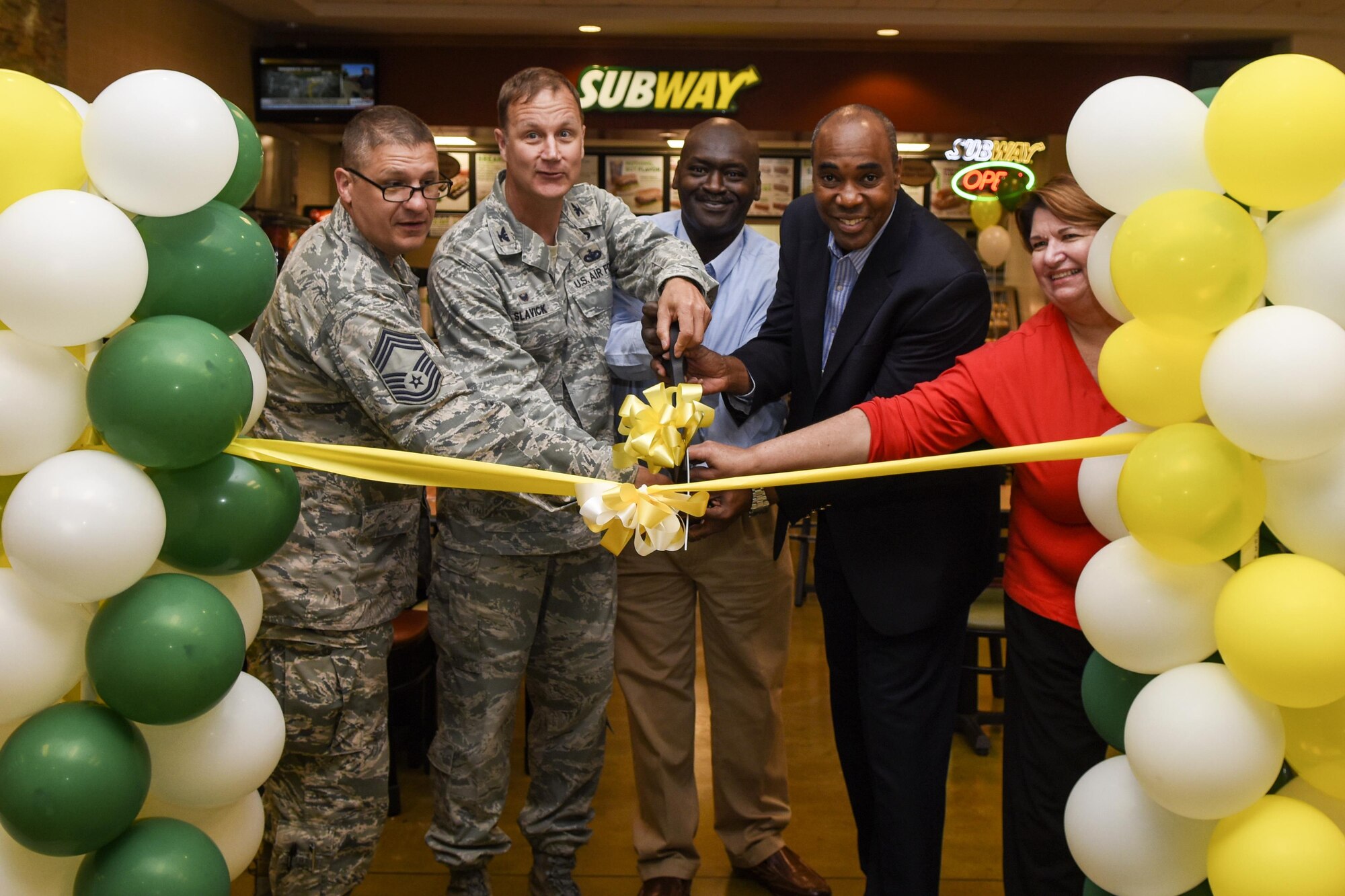 Col. Joseph Slavick (second to the right), 4th Mission Support group commander, along with Vincent James, Fort Bragg Exchange general manager, and representatives from the Seymour Johnson Air Force Base Exchange and Subway restaurant cut a ribbon during the grand opening, June 10, 2016, at Seymour Johnson Air Force Base, North Carolina. Subway held a soft opening May 6 for base personnel. (U.S. Air Force photo by Airman Shawna L. Keyes/Released)  