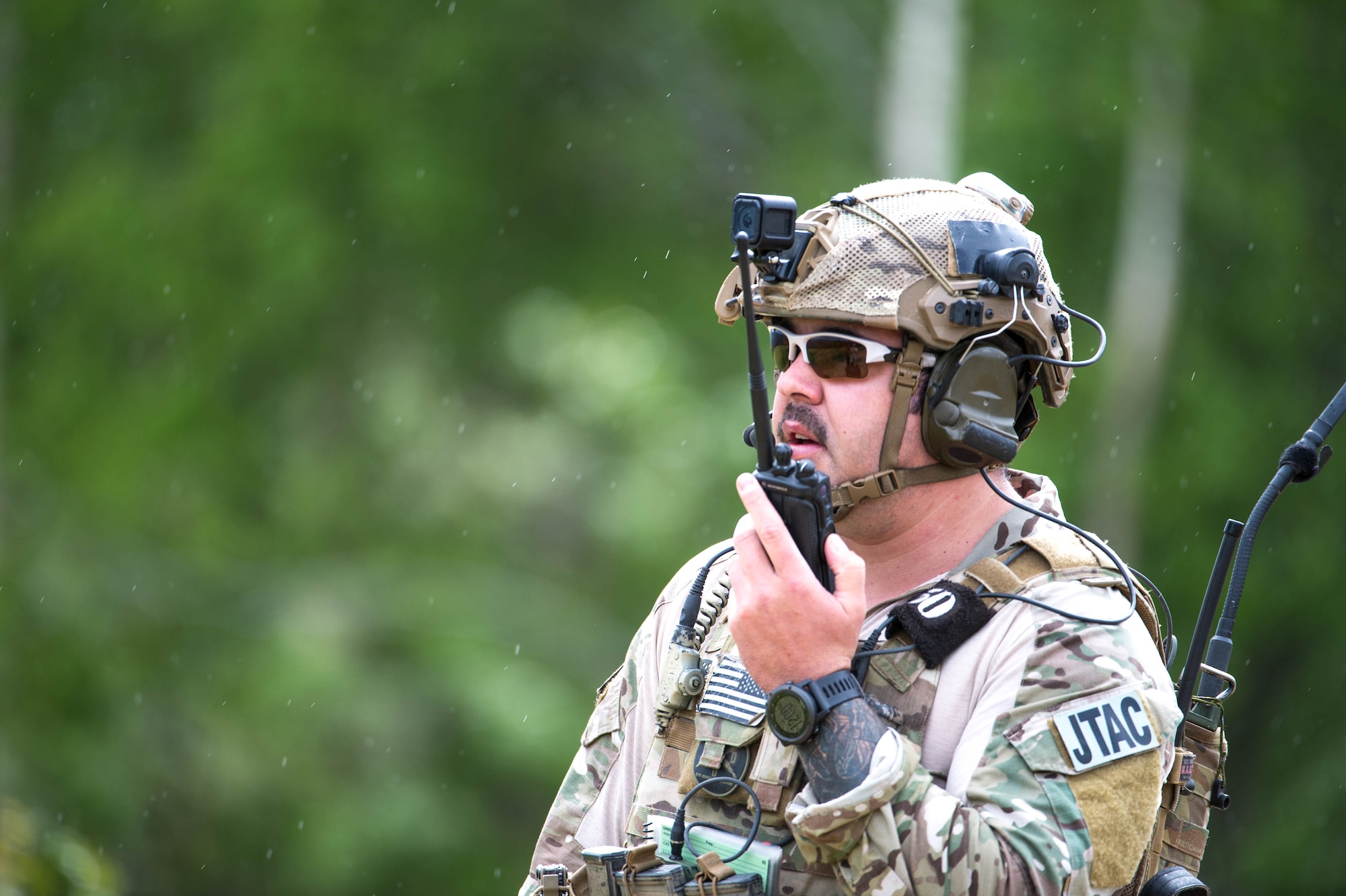 U.S. Air Force Staff Sgt. Jacob Rinker, a 13th Air Special Operations Squadron joint terminal attack controller out of Fort Carson, Colo., coordinates close air support through rain and cloud cover for U.S. Soldiers in the Joint Pacific Alaska Training Range, June 8, 2016, during RED FLAG-Alaska 16-2. The exercise provides unique opportunities to integrate various forces into joint, coalition and multilateral training from simulated forward operating bases. (U.S. Air Force photo by Staff Sgt. Shawn Nickel/Released)