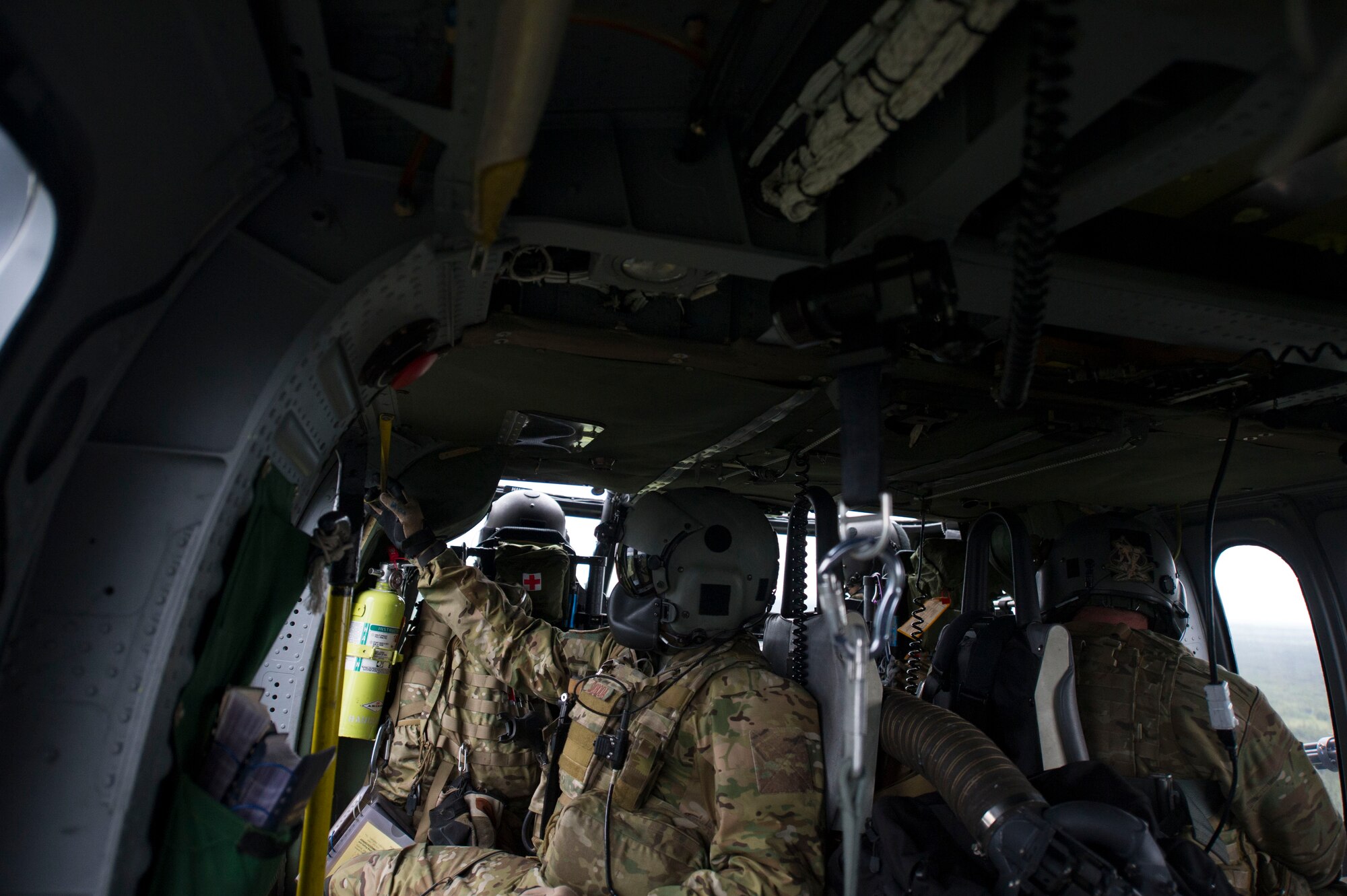 Alaska Air National Guard Airmen assigned to the 210th Rescue Squadron Detachment 1, Eielson Air Force Base, Alaska, prepare for routine training while riding in an HH-60 Pave Hawk June 9, 2016,  in the Joint Pacific Alaskan Range Complex. Along with providing Alert support for Eielson Air Force Base the 210th RQS also provides assistance to the U.S. Coast Guard, Alaskan State Troopers, and National Park Service. (U.S. Air Force photo by Airman Isaac Johnson)
