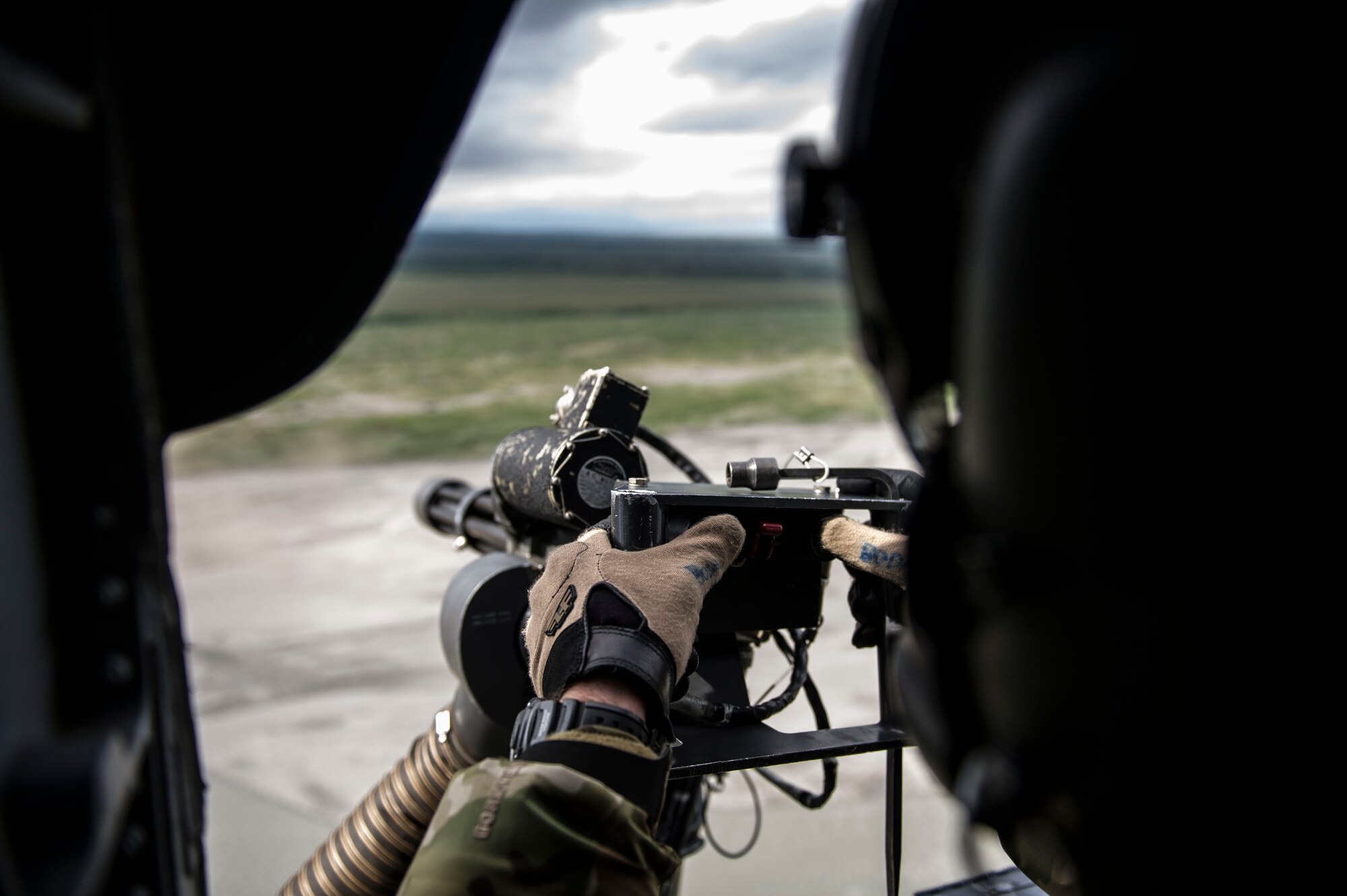 Alaska Air National Guard Tech. Sgt. Jhern Svoboda, a special missions aviator assigned to the 210th Rescue Squadron Detachment 1, Eielson Air Force Base, Alaska, fires a .50 caliber machine gun on a HH-60 Pave Hawk, June 9, 2016, in the Joint Pacific Alaskan Range Complex. The HH-60G Pave Hawk features two .50 caliber machine guns that are operated by qualified crew members. (U.S. Air Force photo by Airman Isaac Johnson)
