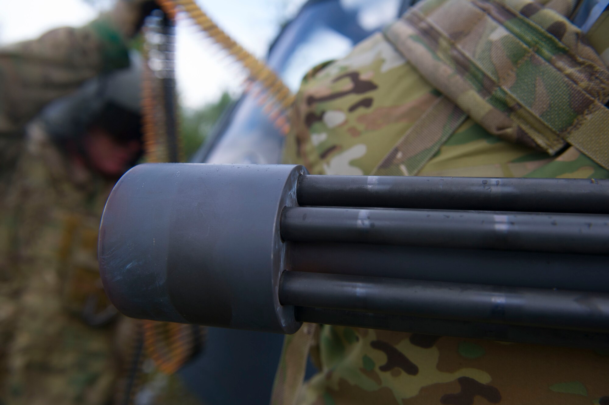 A detailed view of the heated barrel of a .50 caliber machine gun on an Alaska Air National Guard HH-60 Pave Hawk assigned to the 210th Rescue Squadron Detachment 1, Eielson Air Force Base, Alaska, while it is being reloaded June 9, 2016, in the Joint Alaskan Pacific Range Complex. The crew of the aircraft stopped to perform a reload as part of their training. (U.S. Air Force photo by Airman Isaac Johnson)
