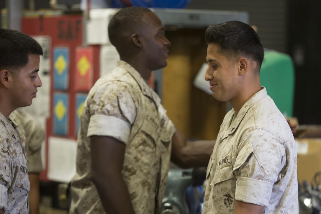 Lance Cpl. Edwin Salgado, motor transport operator, 7th Marine Regiment, is congratulated by fellow Marines after receiving the Road Warrior Award in building 1951 aboard Marine Corps Air Ground Combat Center Twentynine Palms, Calif., June 2, 2016. The award is presented to any military or government civilian employee who operates government motor vehicles and achieves mishap or violation-free driving in 2,500-mile increments. (Official Marine Corps photo by Cpl. Medina Ayala-Lo/ Released)