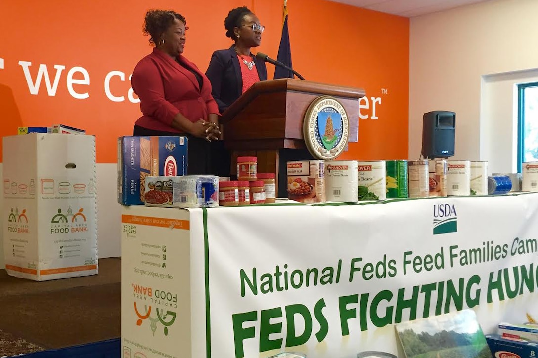 Robin Dorsey of the Coast Guard and NaRochelle Hammond of the Defense Department deliver remarks during the 2016 Feds Feed Families kickoff event at the Capital Area Food Bank in Washington, D.C., June 10, 2016. DoD photo by Susan Suddarth