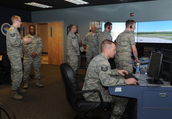 Tech. Sgt. William Olson, 334th Training Squadron instructor, shows Chief Master Sgt. Calvin Williams, Air Force Global Strike Command command chief master sergeant, the air traffic control tower simulator at Cody Hall June 10, 2016, Keesler Air Force Base, Miss. Williams also received mission briefings from 2nd Air Force and the 85th Engineering Installation Squadron during his site visit. (U.S. Air Force photo by Kemberly Groue)