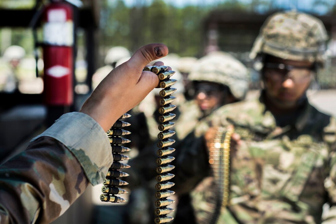 Soldiers receive a belt of 5.56 mm rounds before firing the M249 light machine gun on the weapons demonstration range at Fort Jackson, S.C., June 8, 2016. The soldiers, in their 6th week of basic training are assigned to Company A, 3rd Battalion, 39th Inf. Regiment. Army photo by Sgt. 1st Class Brian Hamilton