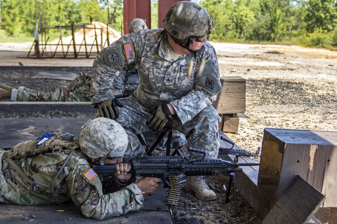 Army Staff Sgt. Zochert, back, watches as a soldier fires his M249 light machine gun at targets downrange on the weapons demonstration range at Fort Jackson, S.C., June 8, 2016. Army photo by Sgt. 1st Class Brian Hamilton