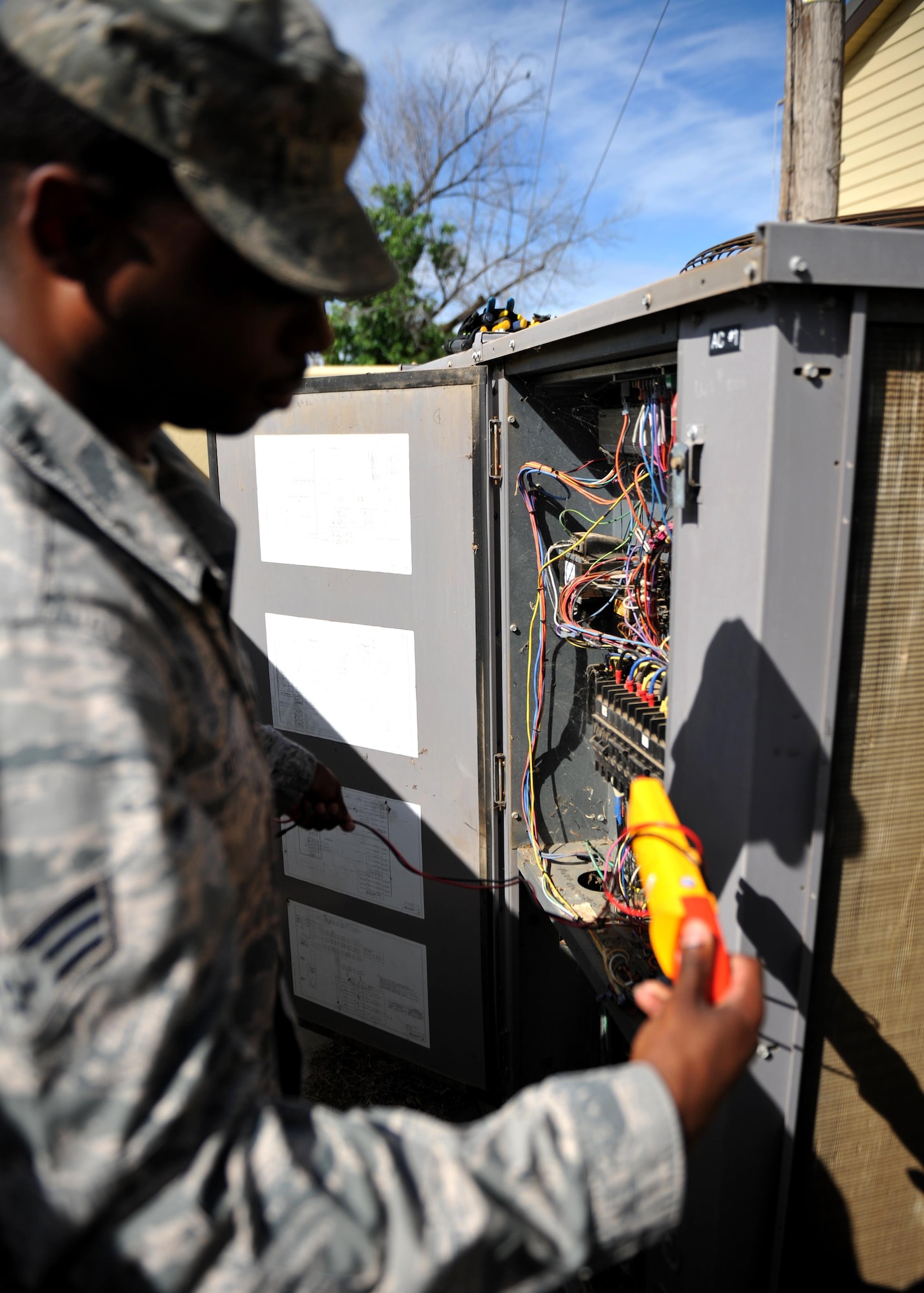 Senior Airman Lecassius Boyle, 9th Civil Engineer Squadron Heating, Ventilation and Air Conditioning (HVAC) technician, checks the electrical current going to the unit May 23, 2016, at Beale Air Force Base, California. HVAC technician’s install, operate, maintain, and repair heating, ventilation, air conditioning, and refrigeration (HVAC/R) systems, combustion equipment, and industrial air compressors. In addition, they also maintain and repair non-electric kitchen equipment. (U.S. Air Force photo by Staff Sgt. Jeffrey Schultze)