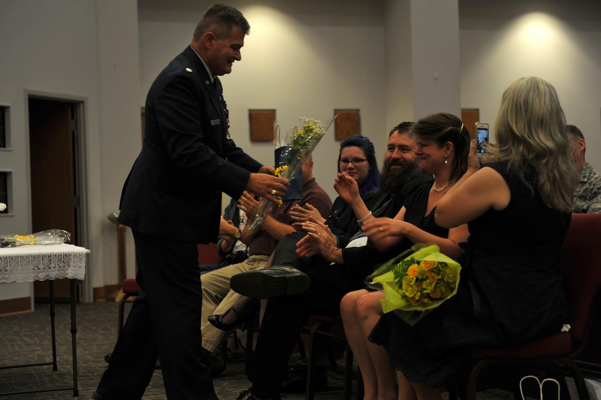 U.S. Air Force Chaplain (Lt. Col.) John Tillery, 17th Training Wing, gives gifts to his family in appreciation of their support for his military career during his retirement ceremony at the Taylor Chapel on Goodfellow Air Force Base, Texas, June 6, 2016. Tillery’s family would be actively involved in the singing of the Air Force Hymn and pinning on his medals. (U.S. Air Force photo by Airman 1st Class Caelynn Ferguson/Released)