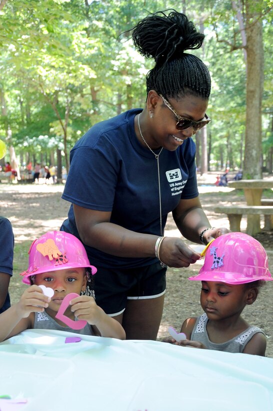 Huntsville Center EEO Specialist Stephanie Caldwell decorates hats with her daughters Raylin and Riley.
