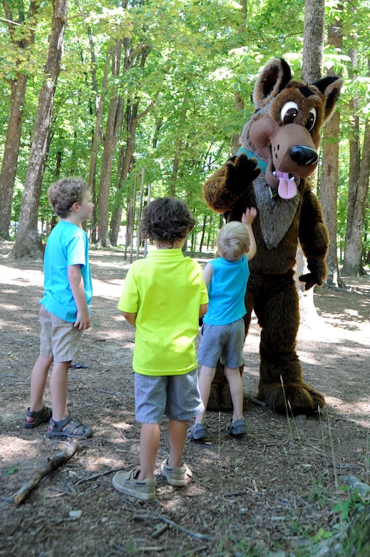 Bomb safety expert SGT Woof, part of the U.S. Army's Unexploded Ordnance (UXO) Safety Education Campaign Program, greets kids at the picnic.
