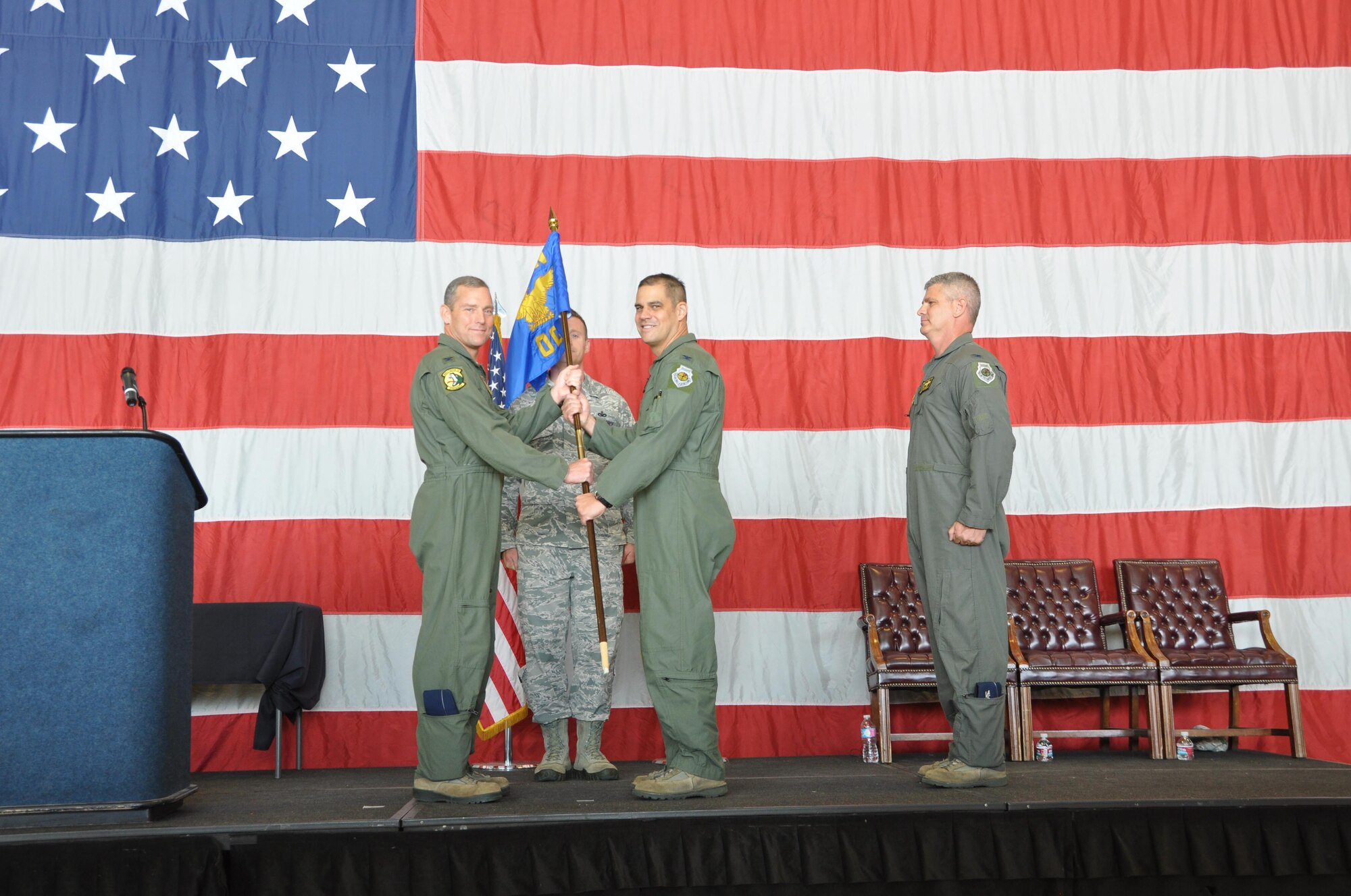 Col. David Smith, 419th Fighter Wing commander, passes the 419th Operations Group flag to Col. David Castaneda during a change of command ceremony here June 12. (U.S. Air Force photo/Staff Sgt. Christina Judd)