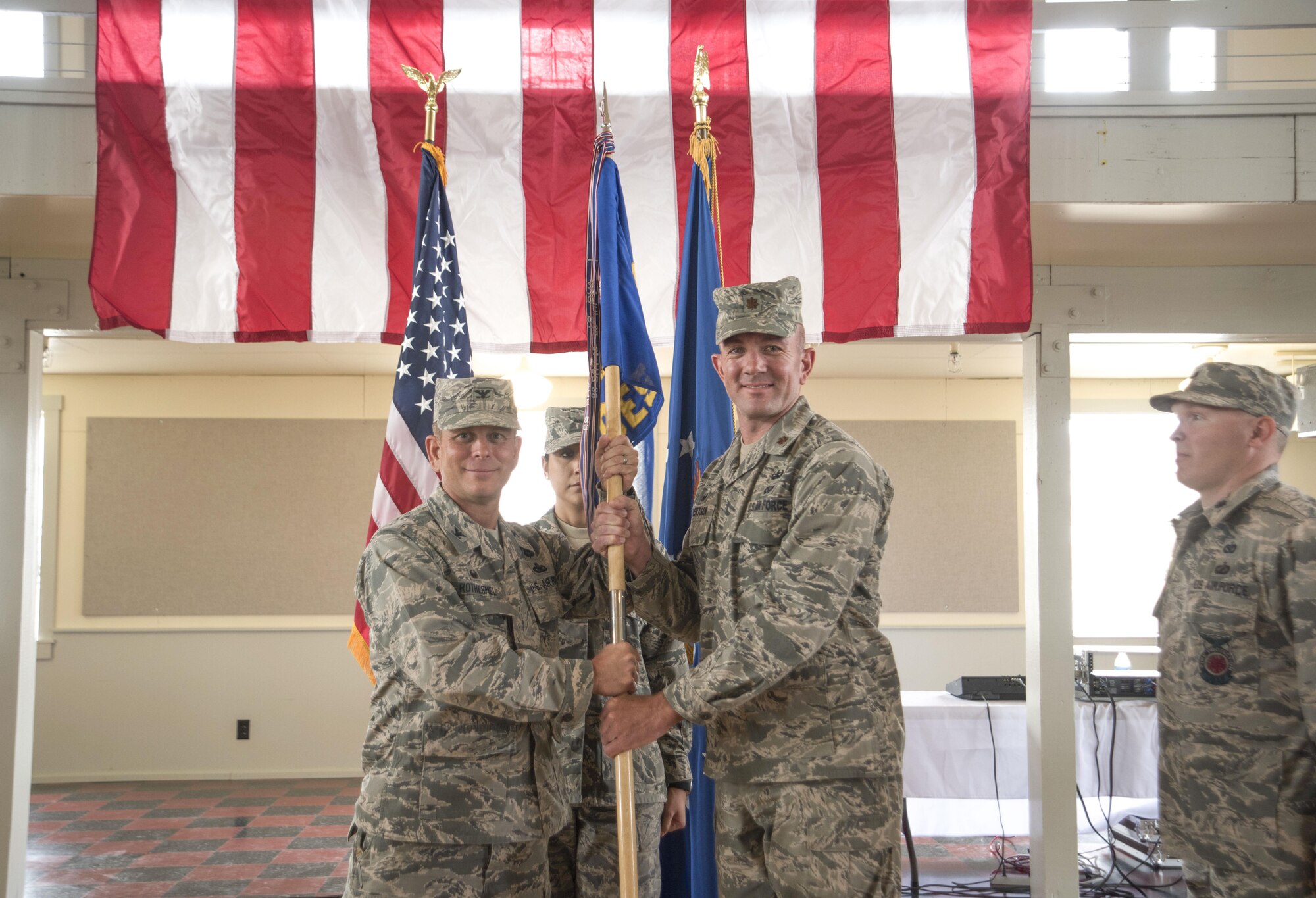 Col. Michael Rothermel, 419th Mission Support Group commander, passes the 419th Civil Engineer Squadron flag to Maj. Mark Eilertsen as he assumes command of the CES June 10. (U.S. Air Force photo/Tech. Sgt. Nathan Campbell)