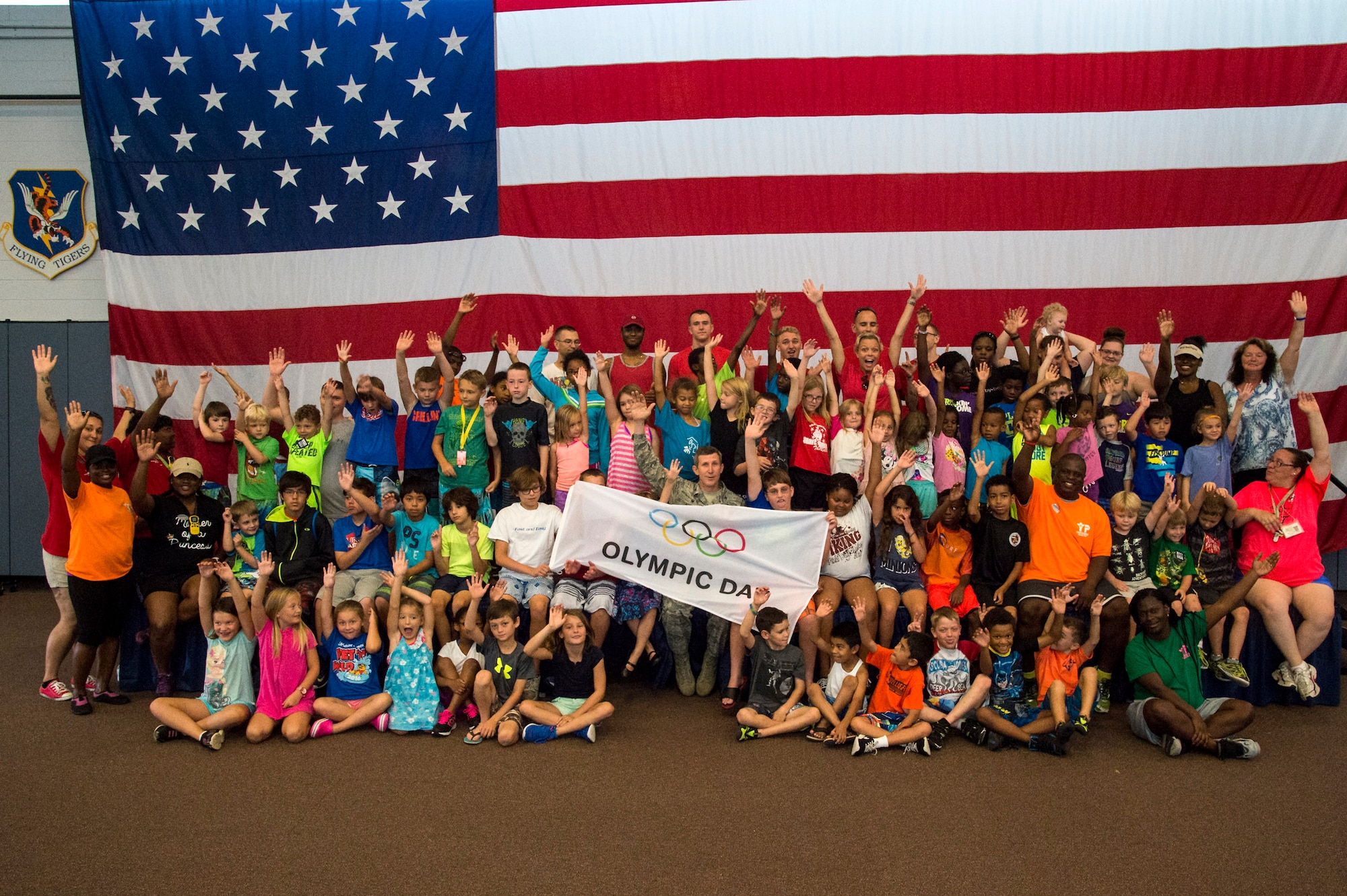 Children from Moody’s Youth Programs pose for a photo with U.S. Air Force Col. Thomas Kunkel, 23d Wing commander, to kick off Olympic Day, June 10, 2016, at Moody Air Force Base, Ga. Olympic Day is designed to engage youth and promote the ideals of the Olympic movement through family-friendly activities and interactive learning experiences. (U.S. Air Force photo by Airman 1st Class Janiqua P. Robinson/Released)