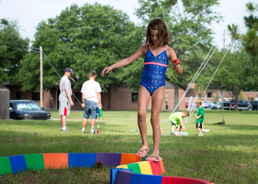 A child from Moody’s Youth Programs tries to keep her balance while holding an egg on a spoon during Olympic Day, June 10, 2016, at Moody Air Force Base, Ga. Moody’s event is one of more than 1,200 events taking place nationwide between May and June in support of Olympic Day. (U.S. Air Force photo by Airman 1st Class Janiqua P. Robinson/Released)