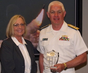WASHINGTON (June 2, 2016) Navy Strategic Systems Programs (SSP) Director Vice Adm. Terry Benedict presents the SSP Director's Award to Naval Surface Warfare Center Dahlgren Division (NSWCDD) senior scientist Kim Payne for leadership impacting the Fleet Ballistic Missile Program. Payne was honored for her expertise in fire control software and targeting models as well as quality assurance methodology enhancements to improve Fleet Ballistic Missile deployed software product effectiveness and efficiency.  Benedict said her efforts, “directly contributed to the Fleet Ballistic Missile Program and successful SSGN (Ohio-class guided-missile submarine) conversion software initiatives.”  (U.S. Navy photo/Released)