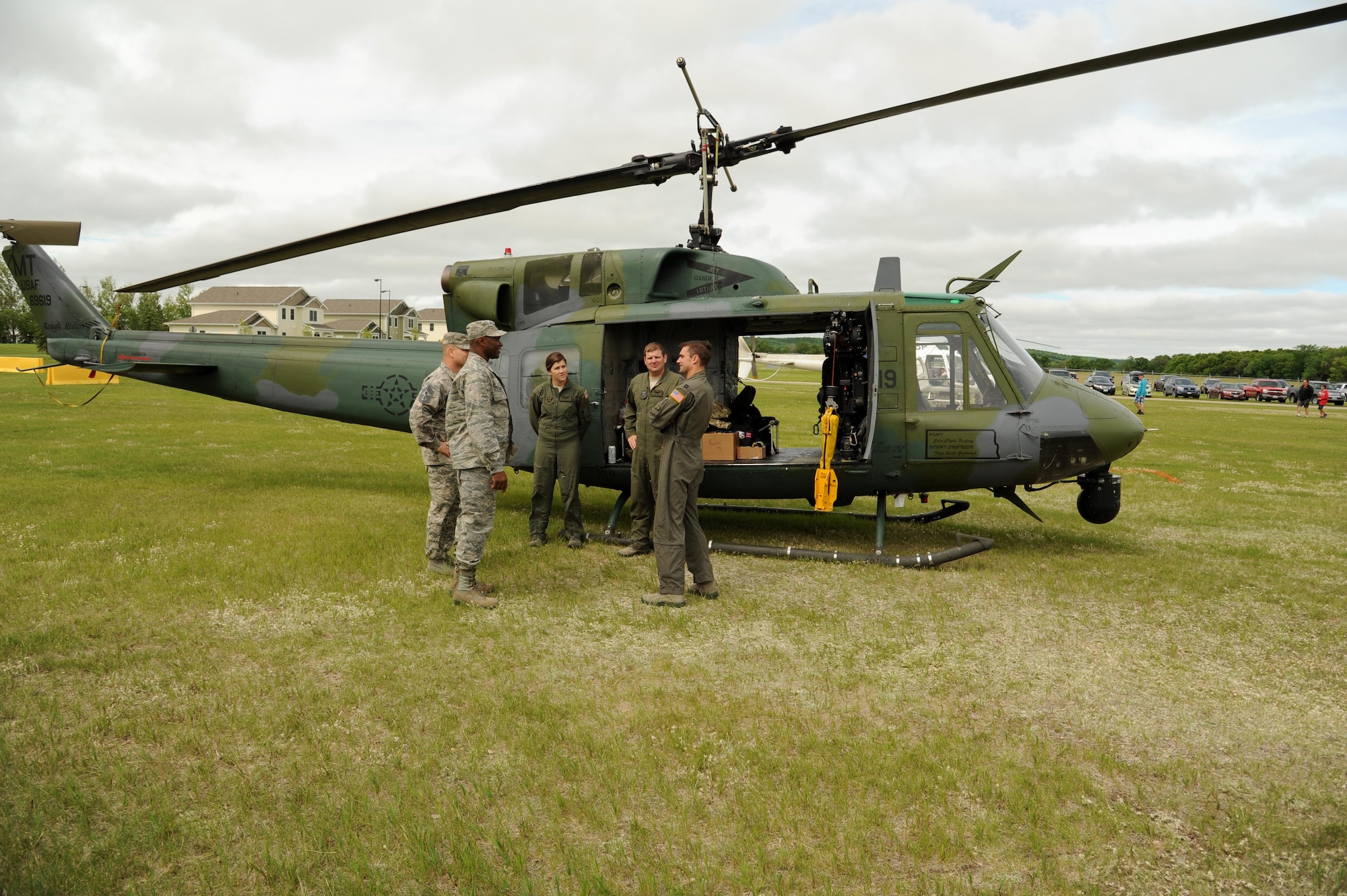 319th Air Base Wing leadership speaks with the crew of an UH-1N Huey helicopter June 11, 2016, on Cavalier Air Force Station, N.D. The crew belongs to the 54th Helicopter Squadron from Minot Air Force Base, N.D. They flew to Cavalier AFS to support an open house for the local community. (U.S. Air Force photo by Senior Airman Ryan Sparks/Released)