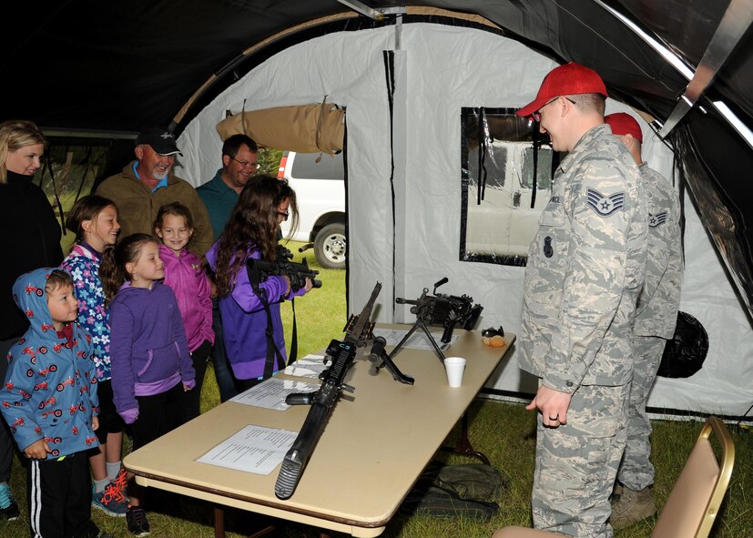 Combat arms instructors from the 319th Security Forces Squadron show local community members a variety of weapons June 11, 2016, on Cavalier Air Force Station, N.D. The 10th Space Warning Squadron hosted an open house to allow the community to see what the installation does on a regular basis. (U.S. Air Force photo by Senior Airman Ryan Sparks/Released)