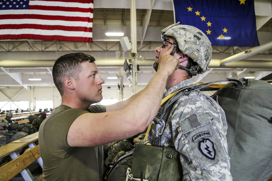 Army 1st Lt. Tyler Sinisgalli, left, inspects Army Spc. Ian Cook before participating in an airborne operation during Arctic Aurora 2016 at Joint Base Elmendorf-Richardson, Alaska, June 2, 2016. Sinisgalli is a jumpmaster assigned to the 25th Infantry Division’s 1st Battalion, 501st Parachute Infantry Regiment, and Cook is assigned to the 25th Infantry Division’s 3rd Battalion, 509th Parachute Infantry Regiment. The training exercise includes Japanese army soldiers and promotes interoperability. Air Force photo by Alejandro Pena