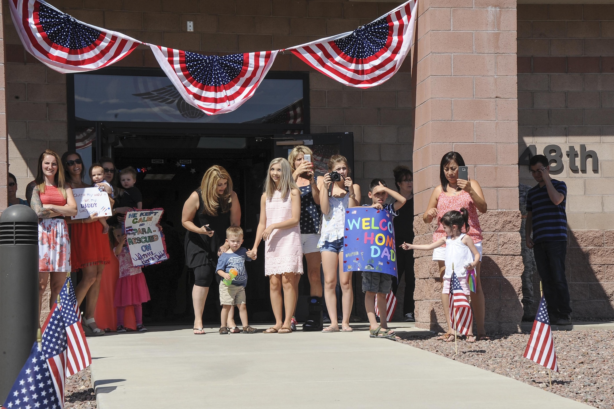 Families wait for the arrival of members assigned to the 48th Rescue Squadron to return home from deployment at Davis-Monthan Air Force Base, Ariz., June 8, 2016. The 48th RQS Airmen were deployed to Turkey in support of Combined Joint Task Force - Operation Inherent Resolve. (U.S. Air Force photo by Airman 1st Class Mya M. Crosby/Released)