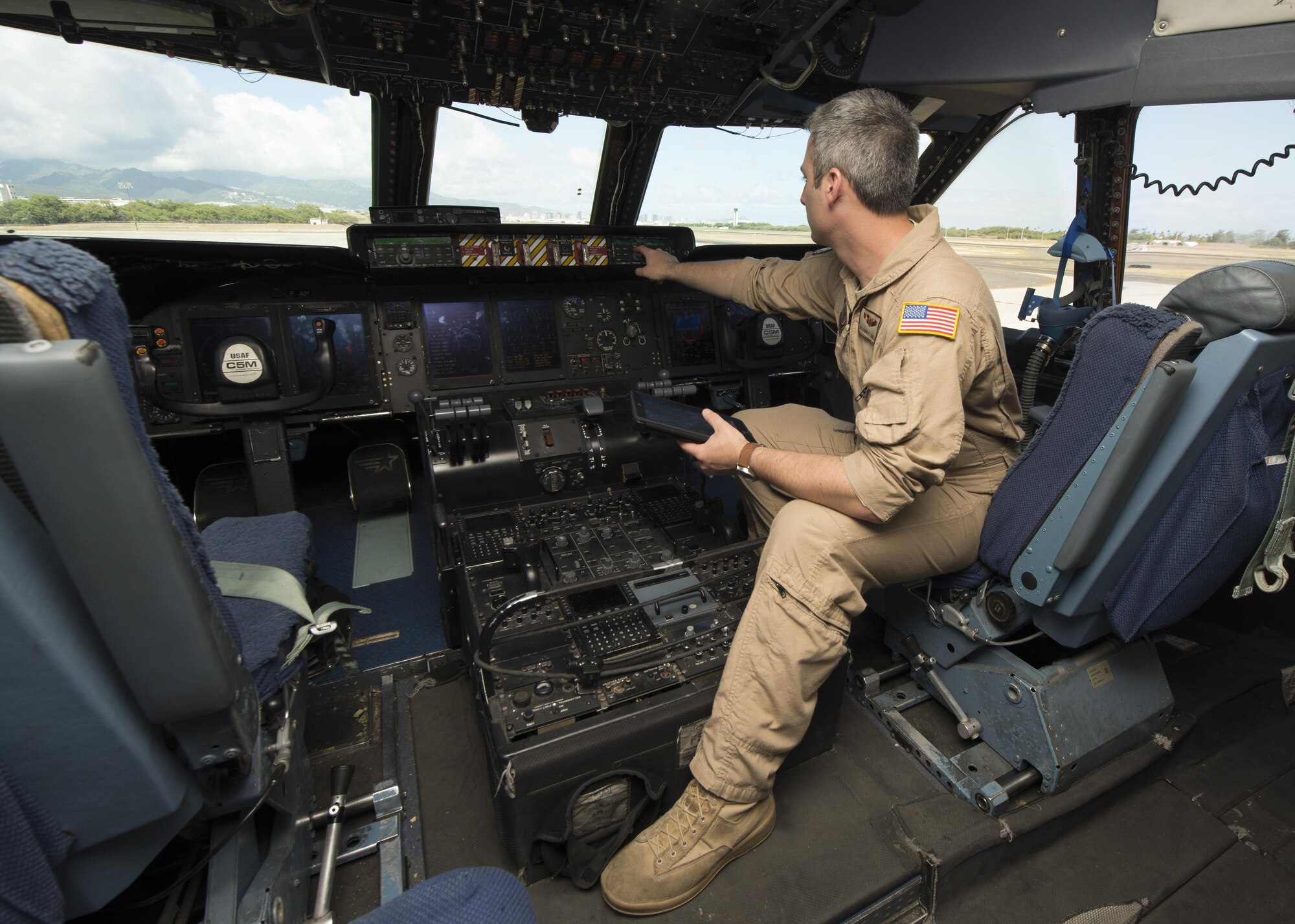 Senior Airman Dominick Lignelli, 9th Airlift Squadron flight engineer, conducts pre-flight procedures prior to take-off May 23, 2016, inside a C-5M Super Galaxy’s flight deck on Joint Base Pearl Harbor-Hickam, Hawaii. Flight engineers are responsible for operating, monitoring and maintaining an aircraft’s systems while in flight. (U.S. Air Force photo/Senior Airman Zachary Cacicia)
