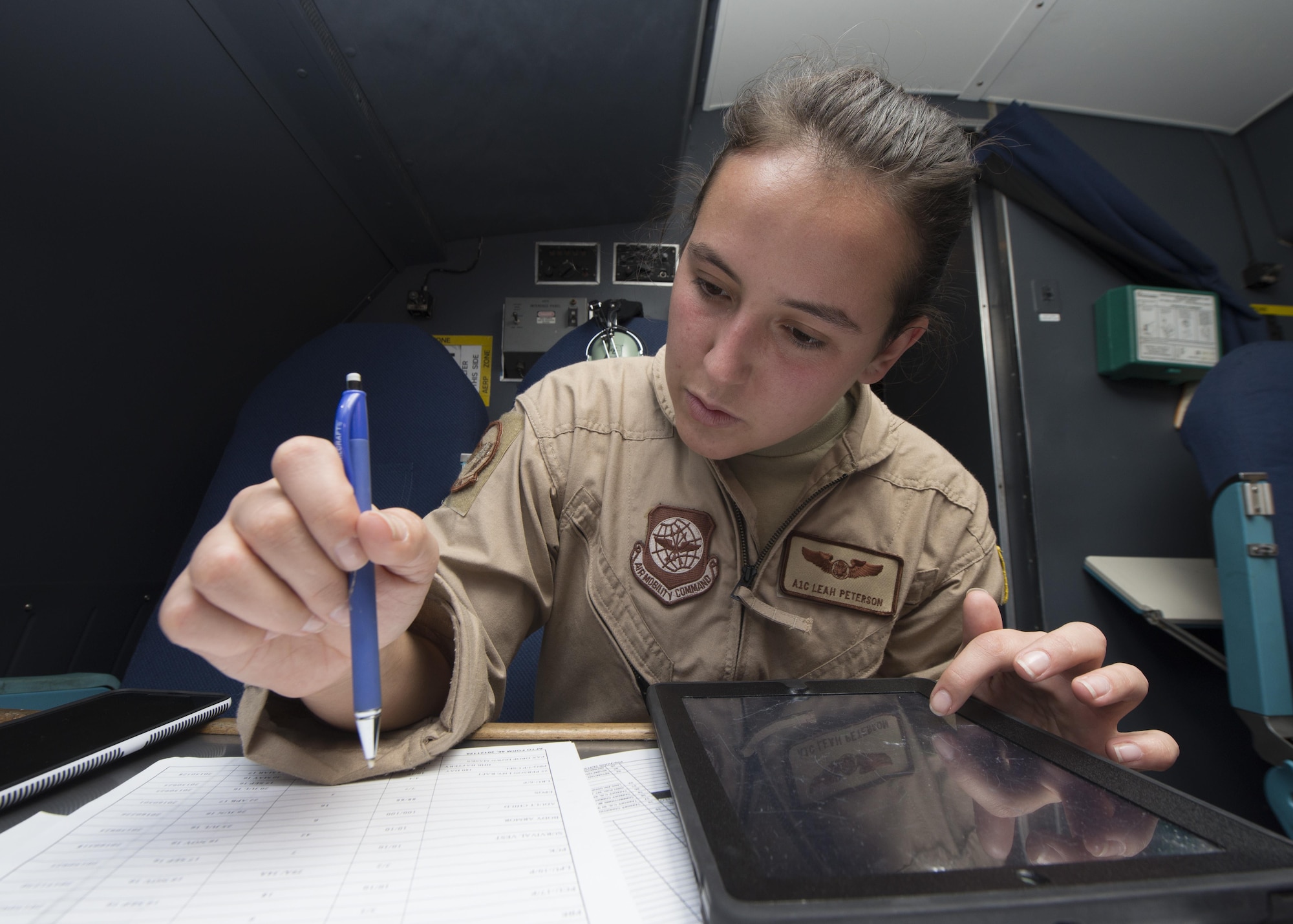 Airman 1st Class Leah Peterson, 9th Airlift Squadron loadmaster, goes over pre-flight procedures prior to take-off May 23, 2016, inside a C-5M Super Galaxy on Joint Base Pearl Harbor-Hickam, Hawaii. An 9th AS aircrew circumnavigated the globe in 14 days. (U.S. Air Force photo/Senior Airman Zachary Cacicia)