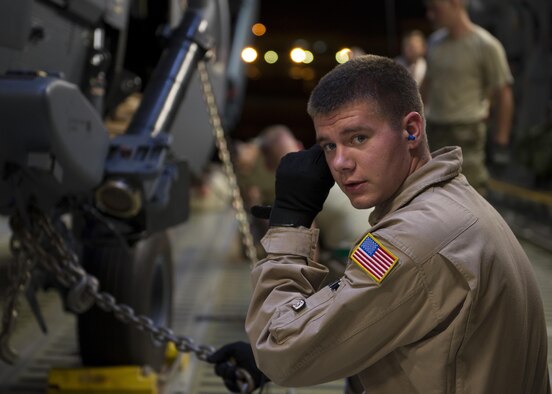 Airman 1st Class Kyle Wake, a 9th Airlift Squadron loadmaster, adjusts his hearing protection while loading two HH-60G Pave Hawks into a C-5M Super Galaxy on May 26, 2016, at Kadena Air Base, Japan. (U.S. Air Force photo/Senior Airman Zachary Cacicia) 