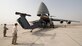 A HH-60G Pave Hawk is off-loaded from a C-5M Super Galaxy on May 30, 2016, at Camp Lemonnier, Djibouti. During its mission while circumnavigating the world, this C-5M transported more than 580,000 pounds of cargo and nearly 400 passengers. (U.S. Air Force photo/Senior Airman Zachary Cacicia)