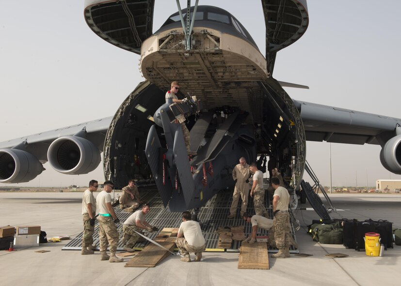 A HH-60G Pave Hawk is off-loaded from a C-5M Super Galaxy May 30, 2016, at Camp Lemonnier, Djibouti. The C-5M is the largest outsized cargo transport aircraft operated by the U.S. Air Force. (U.S. Air Force photo/Senior Airman Zachary Cacicia)