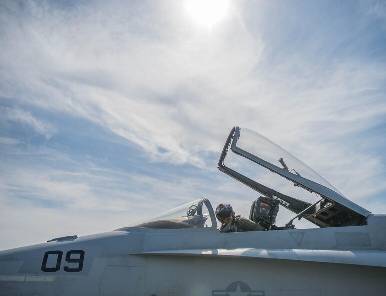 U.S. Marine Corps Stephen Morrison, a Marine Fighter Attack Squadron (VMFA) 314 quality assurance officer, prepares for a June 10, 2016, sortie in the Joint Pacific Alaska Range Complex (JPARC) flying in the number nine jet, which holds the highest flying hours in the U.S. Marine Corps F-18A Hornet inventory, during RED FLAG-Alaska (RF-A) 16-2. The exercise provides unique opportunities to integrate various forces into joint, coalition and multilateral training scenarios from simulated forward operating bases in the JPARC, which at more than 67,000 square miles, is the largest instrumented air, ground and electronic combat training range in the world. (U.S. Air Force photo by Staff Sgt. Shawn Nickel/Released)