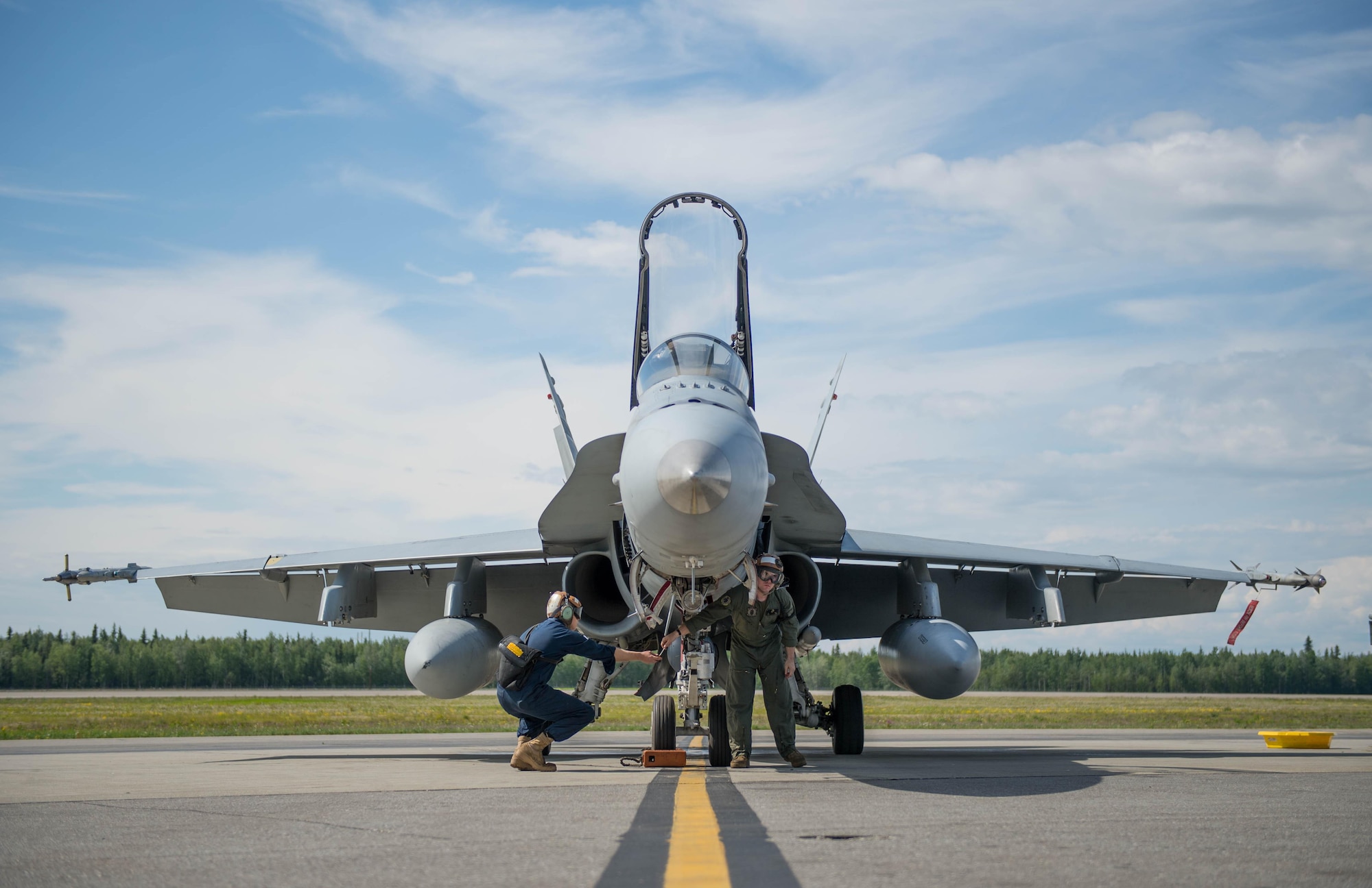 U.S. Marine Corps maintenance technicians from Marine Fighter Attack Squadron (VMFA) 314 based out of Miramar, Calif., prepare their number nine jet, June 10, 2016, which holds the highest flying hours in the U.S. Marine Corps F-18A Hornet inventory, during RED FLAG-Alaska (RF-A) 16-2. RF-A enables joint and international units to sharpen their combat skills by flying simulated combat sorties in a realistic threat environment, which allows them to exchange tactics, techniques and procedures while improving interoperability. (U.S. Air Force photo by Staff Sgt. Shawn Nickel/Released)