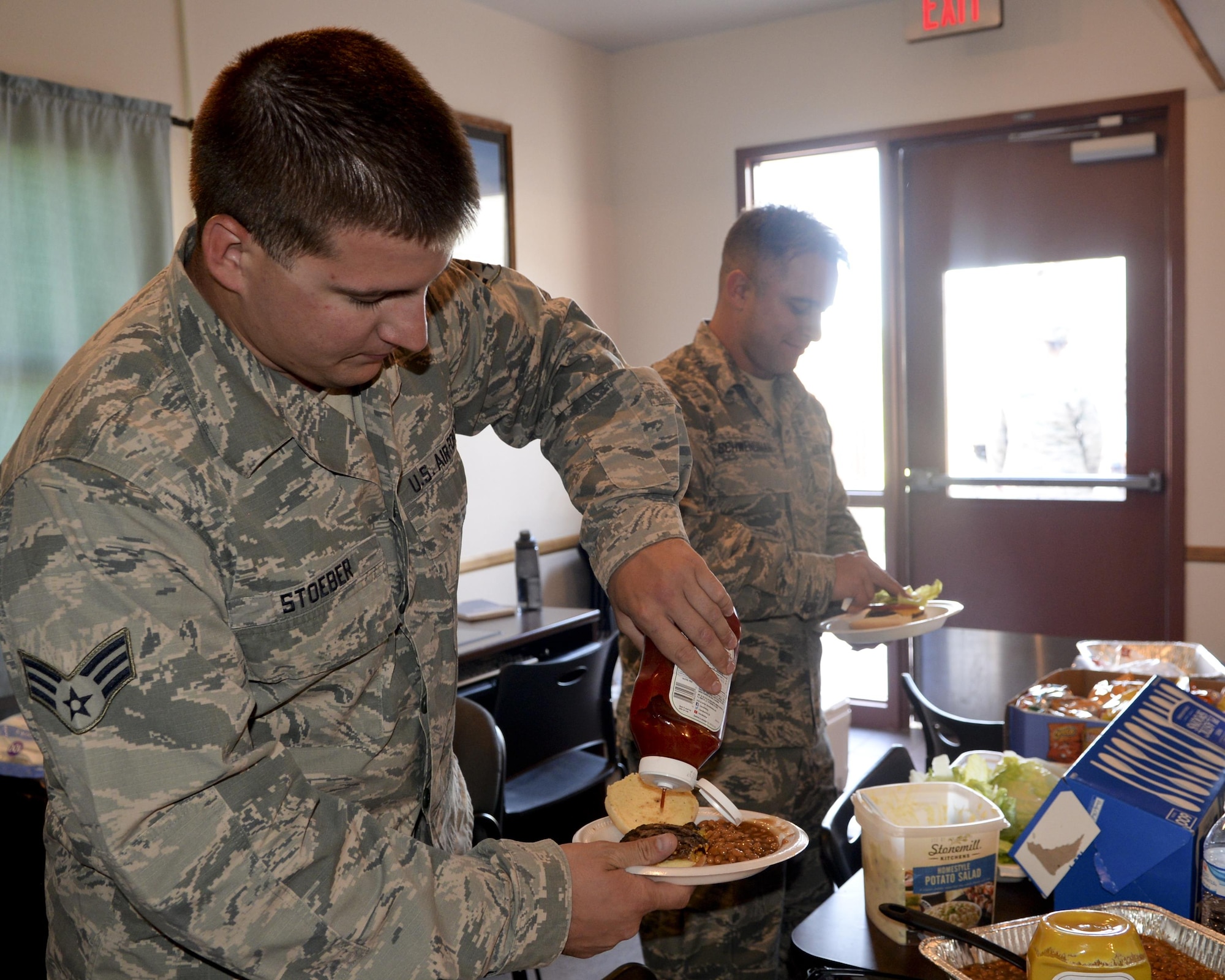 Senior Airman Jordan Stoeber, 90th Missile Maintenance Squadron Electrical Maintenance Team technician, prepares his lunch June 8, 2016, with food provided by leadership from the 319th Missile Squadron leadership in the F.E. Warren Air Force Base, Wyo., missile complex. The different units that are responsible for the cleansing of sensitive components in the missile complex were offered a freshly cooked meal my leaders in the 319th and had plenty of downtime to form bonds outside of their respective career fields. (U.S. Air Force photo by Airman 1st Class Malcolm Mayfield)