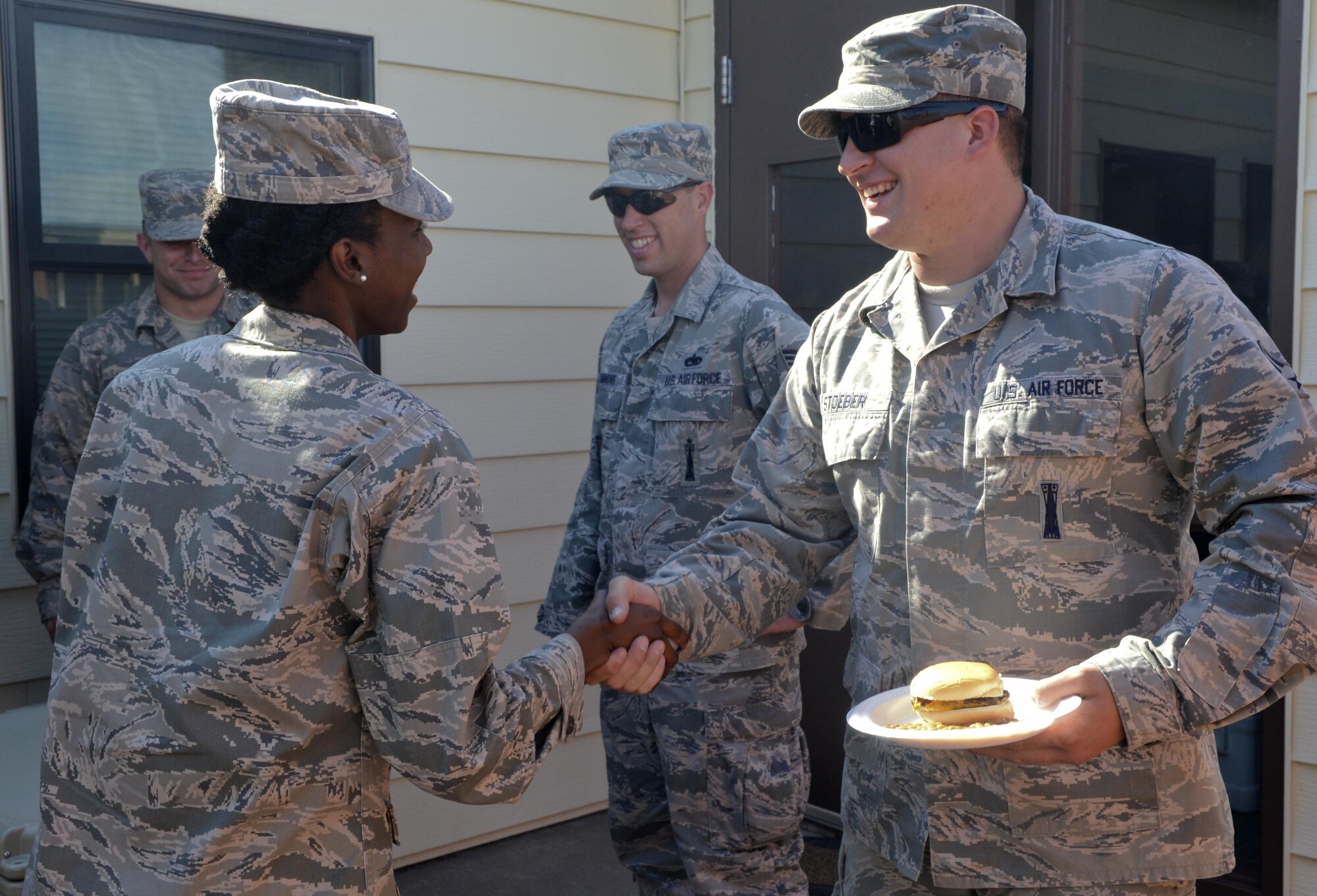 Senior Airman Jordan Stoeber, 90th Missile Maintenance Squadron Electrical Maintenance Team technician, thanks 1st Lt. Krystal Wilder, 319th Missile Squadron missileer, for her part with the cookout June 8, 2016, in the F.E. Warren Air Force Base, Wyo., missile complex. The different units that are responsible for the cleansing of sensitive components in the missile complex were offered a freshly cooked meal my leaders in the 319th and had plenty of downtime to form bonds outside of their respective career fields. (U.S. Air Force photo by Airman 1st Class Malcolm Mayfield)