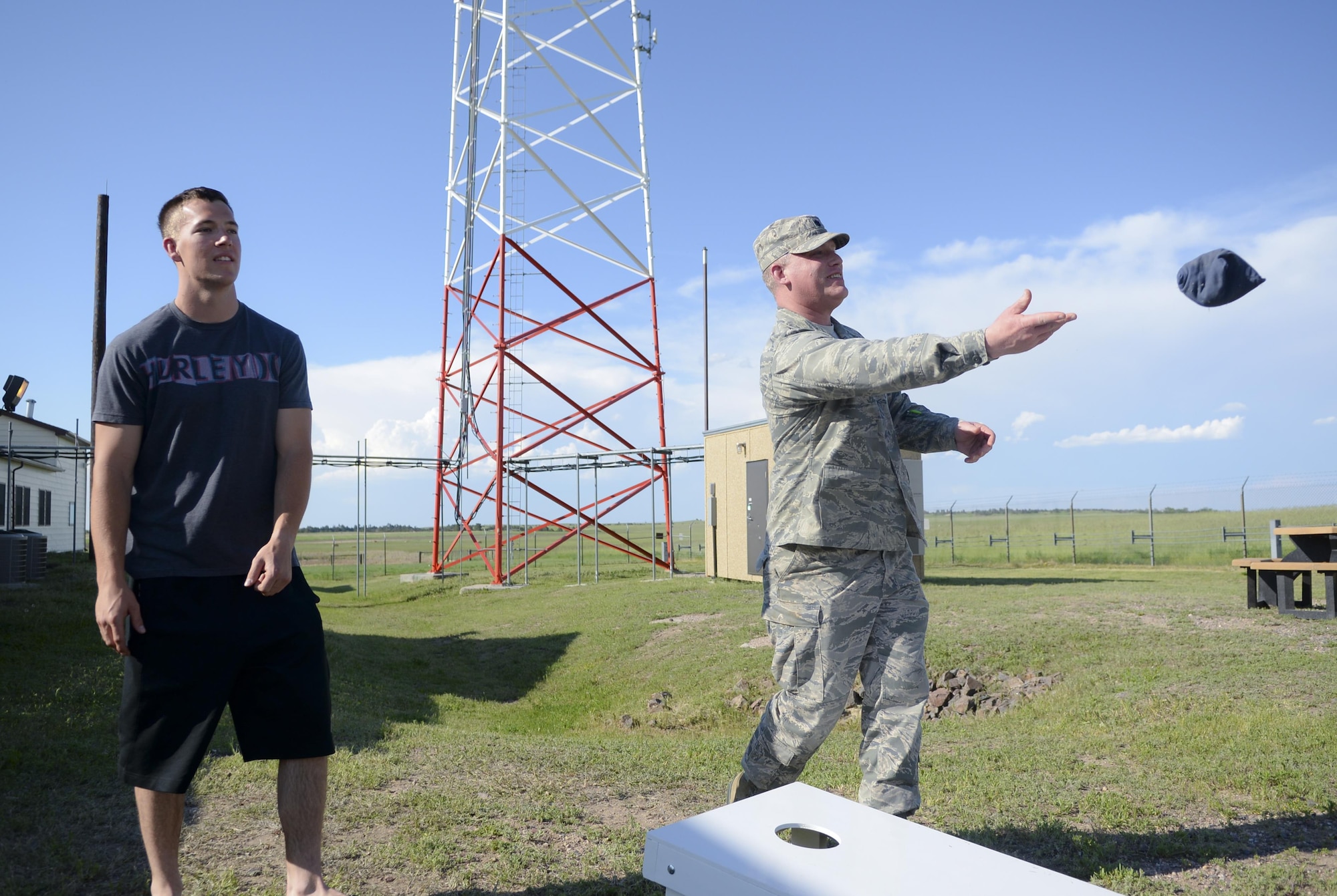 Airman 1st Class Kevin Wuerth, 90th Missile Maintenance Squadron Electrical Maintenance Team technician, plays a game with Lt. Col. Jeremy Olson, 319th Missile Squadron commander, June 8, 2016, in the F.E. Warren Air Force Base, Wyo., missile complex. Security forces, maintenance, chefs and missile crew Airmen were given an opportunity to bond over home cooked meals and make connections across various career fields furthering the camaraderie of the Warren family. (U.S. Air Force photo by Airman 1st Class Malcolm Mayfield)
