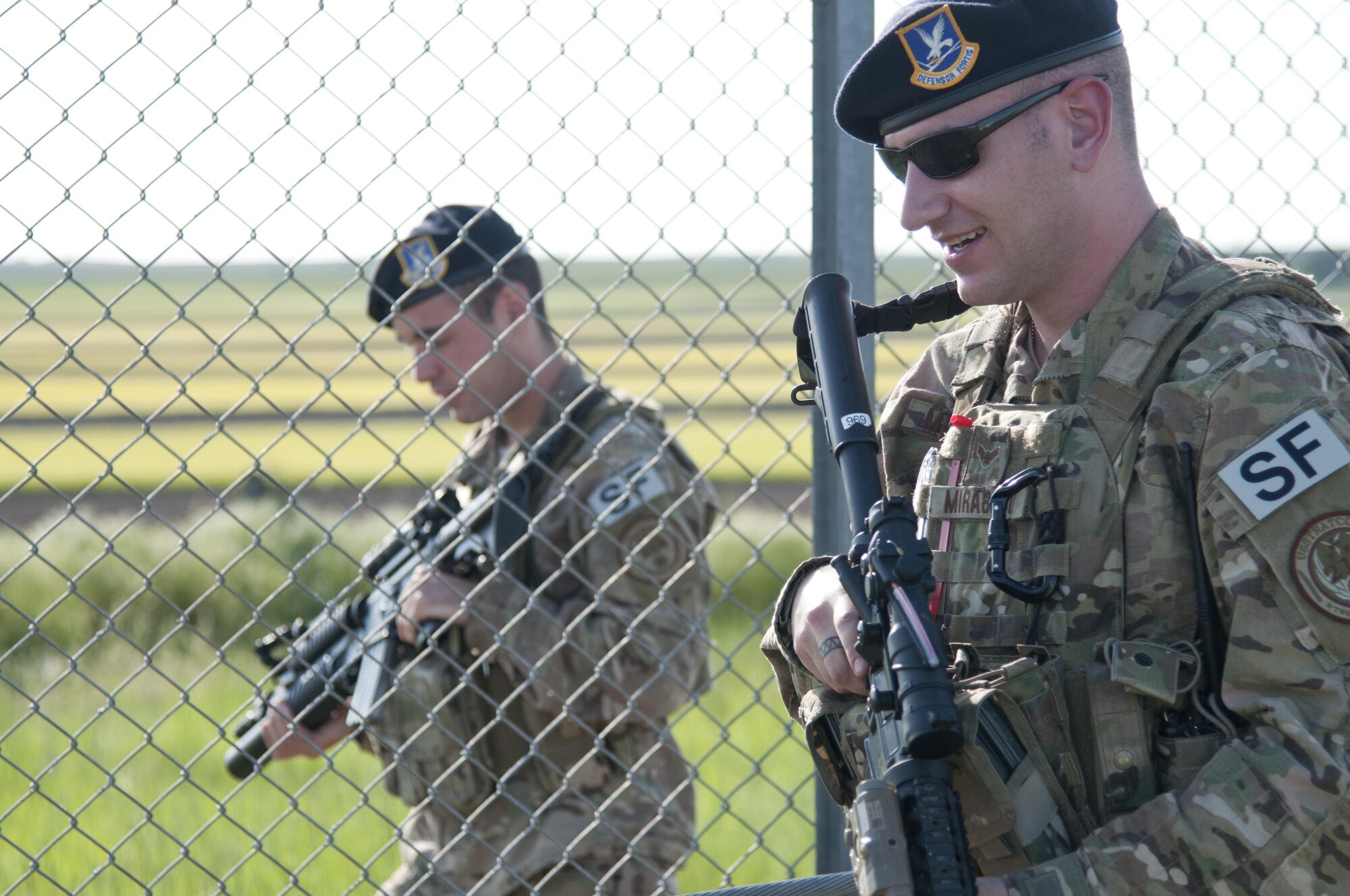 Airmen 1st Class Adam Mirabito and Stefan Williams, 90th Missile Security Forces Squadron members, perform a security sweep around a missile alert facility Jun 13, 2016, in the F.E. Warren Air Force Base, Wyo., missile complex. Before and after the sweep, the security members had time to interact with the other Airmen during the cookout. (U.S. Air Force photo by Airman 1st Class Malcolm Mayfield)