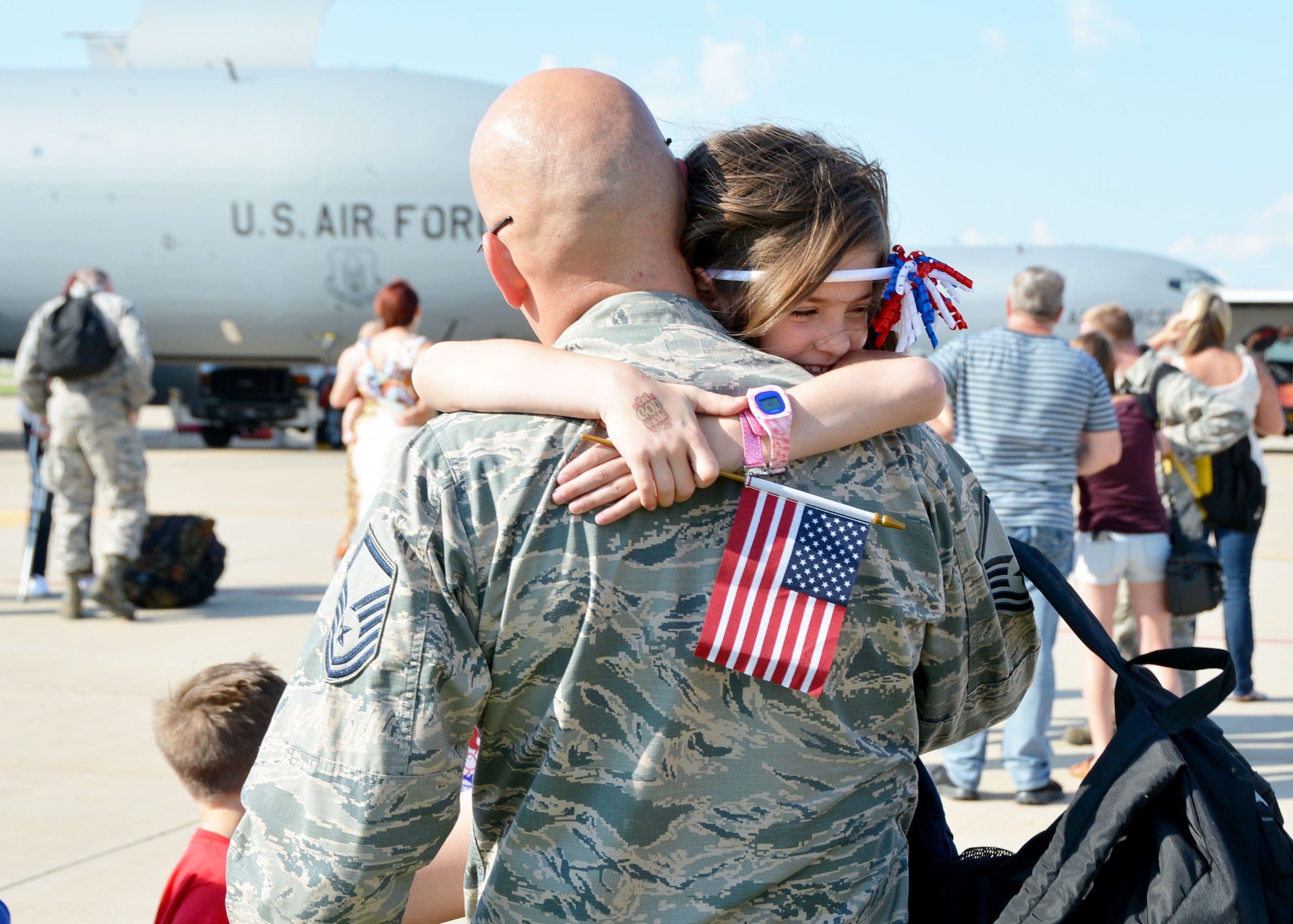 Master Sgt. Shaun Erickson of the 507th Aircraft Maintenance Squadron at Tinker Air Force Base, Okla., and his daughter share a hug June 11, 2016, following his return from a four-month deployment to Southwest Asia. Airmen returning from deployment are encouraged to use the Yellow Ribbon Program, which is a series of events designed to provide members and families with essential resources prior to departure, a level of stability and support during deployment, and successful re-integration techniques after the deployment cycle ends. (U.S. Air Force photo/Tech. Sgt. Lauren Gleason)
