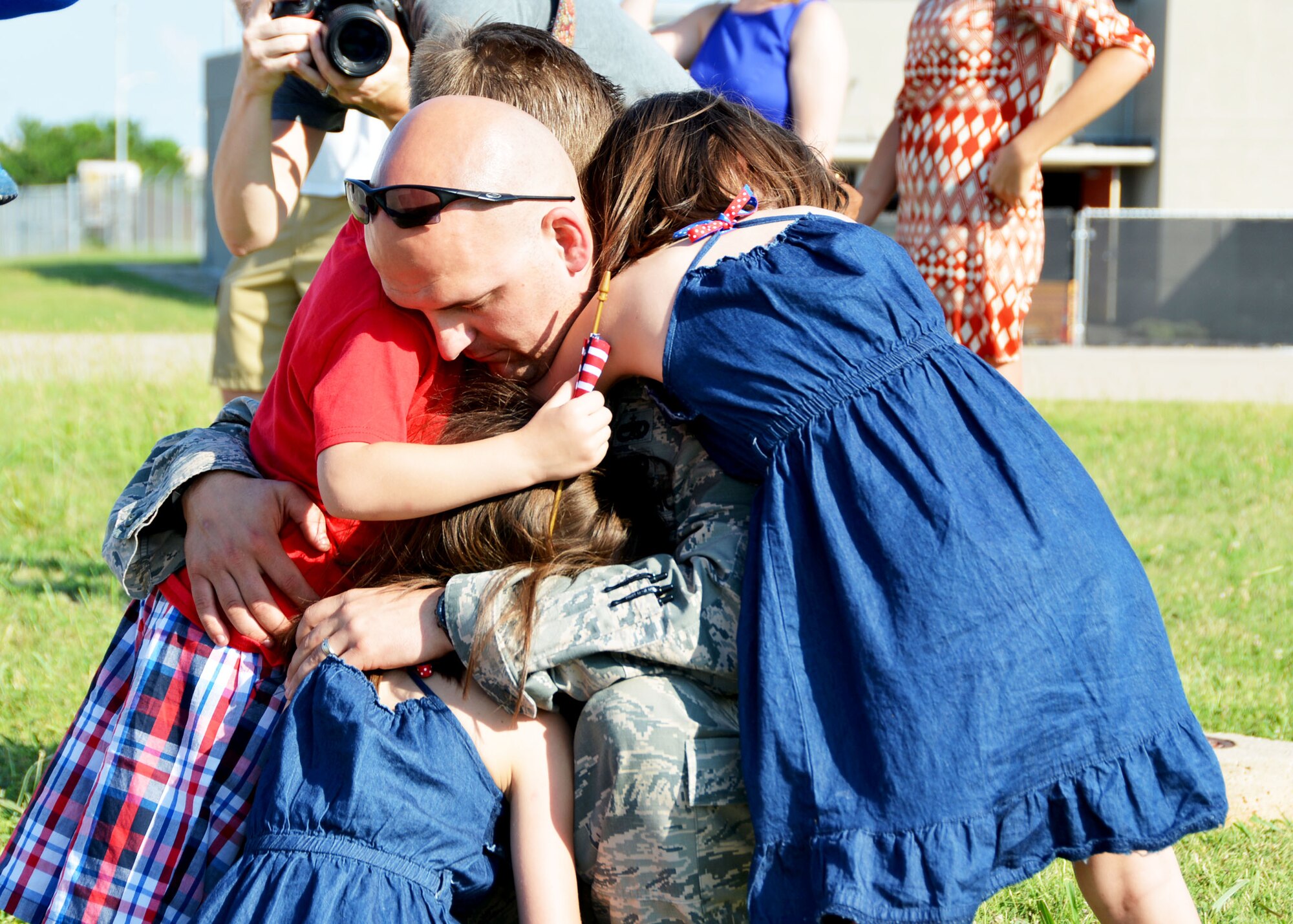 Master Sgt. Shaun Erickson of the 507th Aircraft Maintenance Squadron hugs three of his children June 11, 2016, at Tinker Air Force Base, Okla., following his return from a four-month deployment to Southwest Asia. Reservists in the 507th Air Refueling Wing fly three to four missions daily and off-load millions of pounds of fuel in support of operations worldwide. (U.S. Air Force photo/Tech. Sgt. Lauren Gleason)