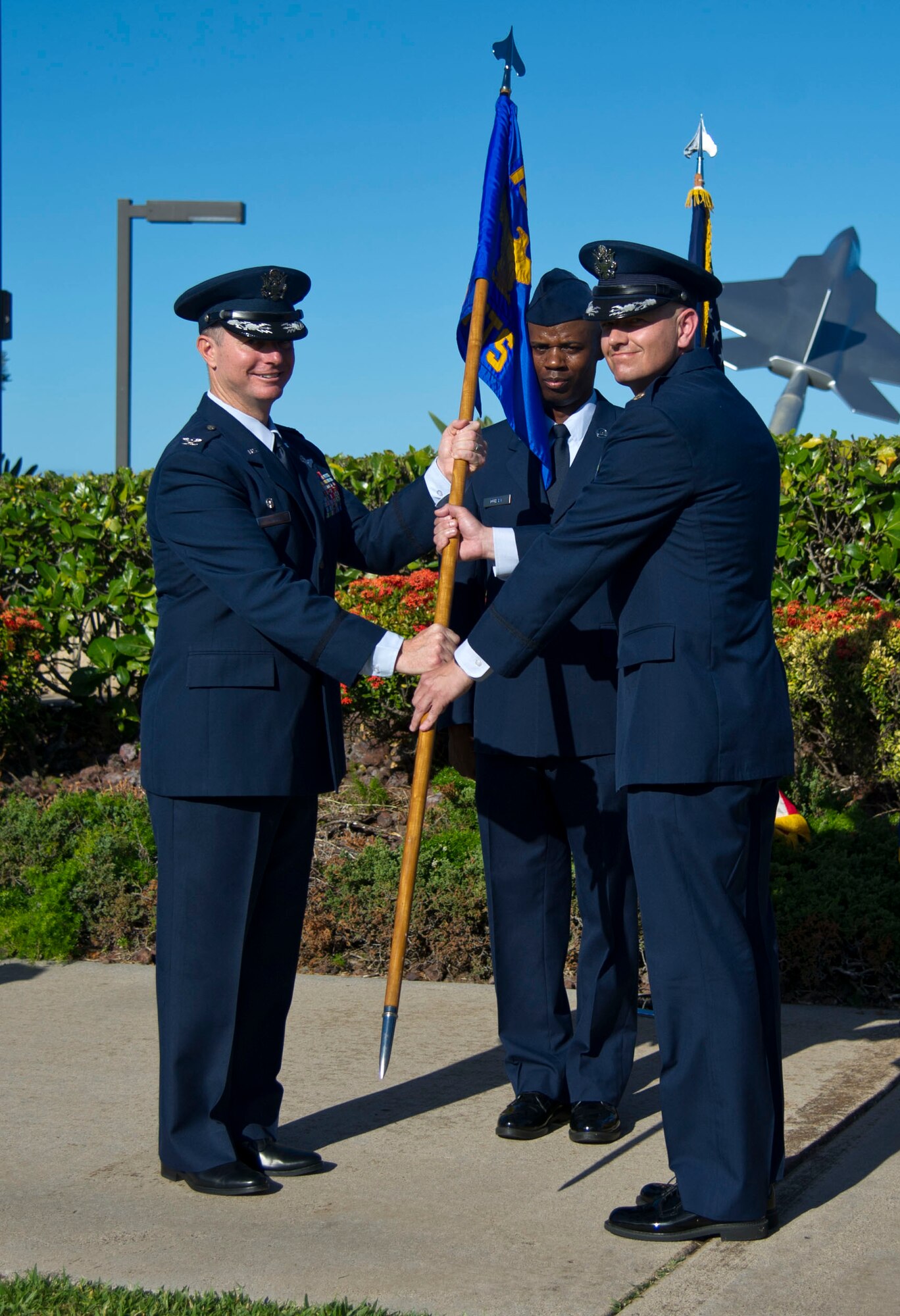 Col. Randy Huiss, 15th Wing commander, hands the guidon to 15th Comptroller Squadron commander, Maj. Andrew Gmytrasiewicz, after the change of command ceremony June 10, 2016, on Joint Base Pearl Harbor-Hickam, Hawaii. Gmytrasiewicz received command from Maj. Dorinda Mazza at a ceremony at the Missing Man formation. (U.S. Air Force photo by Tech. Sgt. Terri Paden/Released)