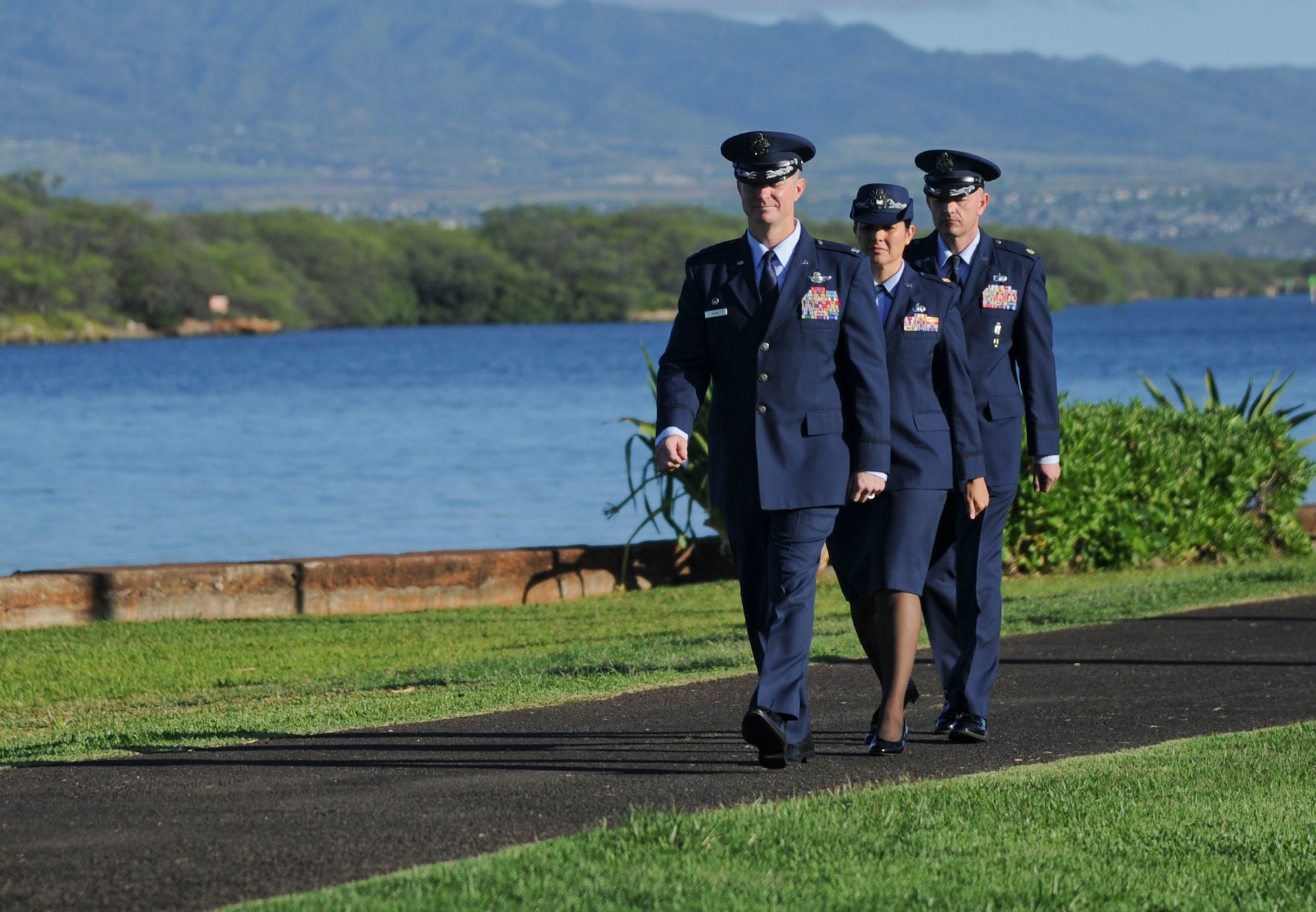 Col. Randy Huiss, 15th Wing commander, leads the way as Maj. Dorinda Mazza, outgoing 15th Comptroller Squadron commander, prepares to hand over command to Maj. Andrew Gmytrasiewicz in a change-of-command ceremony at the Missing Man Formation June 10, 2016, on Joint Base Pearl Harbor-Hickam, Hawaii. (U.S. Air Force photo by Tech. Sgt. Terri Paden/Released)