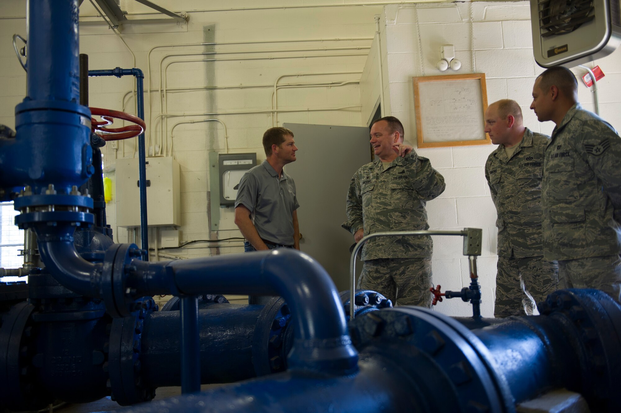 Personnel from the 92nd Civil Engineer Squadron brief Col. Brian McDaniel (center), 92nd Air Refueling Wing commander, about Fairchild’s water reservoir system. The system supplies water to all base personnel to include the military members and base housing facilities. (U.S. Air Force photo/Airman 1st Class Nick J. Daniello)
