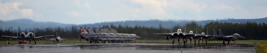 A U.S. Air Force A-10 Thunderbolt II twin-engine, ground-attack aircraft assigned to the 354th Fighter Squadron (FS) out of Davis-Monthan Air Force Base, Ariz., taxis into place next to Republic of Singapore Air Force and U.S. Air Force F-16 Fighting Falcons in preparation for an afternoon sortie from the Eielson Air Force Base, Alaska, flight line alongside taxiing F-15E Strike Eagles deployed from Royal Air Force Lakeneath, England, June 7, 2016, during RED FLAG-Alaska (RF-A) 16-2. Pilots, aircrew, maintainers and support personnel coverge at Eielson for RF-A, is a series of Pacific Air Forces commander-directed field training exercises that enable joint and international forces to sharpen their combat skills by flying simulated combat sorties together in a realistic threat environment. (U.S. Air Force photo by Master Sgt. Karen J. Tomasik/Released)