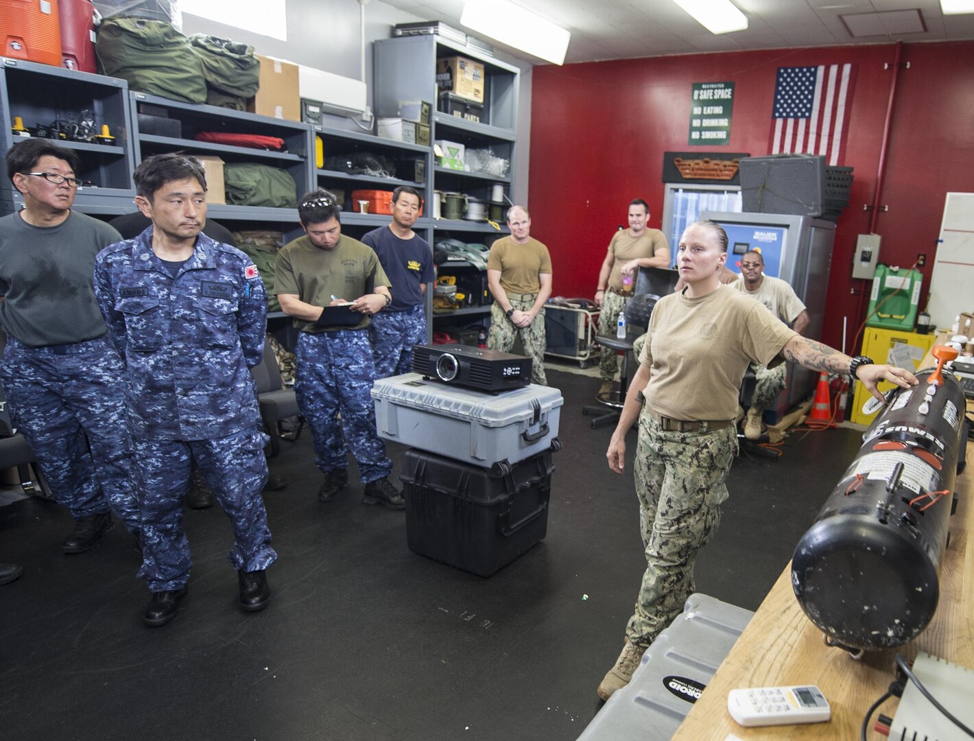 A U.S. Navy Sailor assigned to Explosive Ordnance Disposal (EOD) Mobile Unit One explains the MK18 Mod. 1 unmanned underwater vehicle to Japan Maritime Self-Defense Force (JMSDF) EOD technicians during exercise Malabar 2016. A trilateral maritime exercise, Malabar is designed to enhance dynamic cooperation between the Indian Navy, Japan Maritime Self-Defense Force (JMSDF) and U.S. Navy forces in the Indo-Asia-Pacific. (U.S. Navy combat camera photo by Mass Communication Specialist 1st Class Charles E. White/Released)